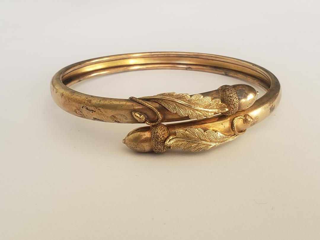 This rare Victorian Gold Vermeil on Silver bypass bangle is one of the most beautiful we've seen from this era. 
The bangle with fine crafted Acorn Motif on the ends.

Acorns are also considered to be a lucky symbol, representing prosperity,