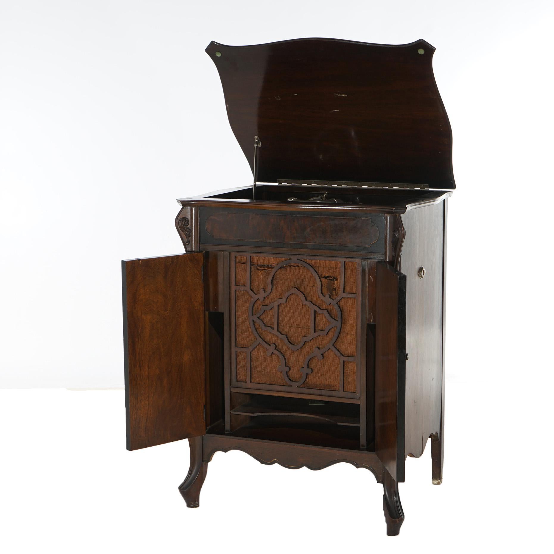 An antique Victorian Victrola phonograph by Silvertone offers Tru-Phonic floor model with mahogany case having flame mahogany accents and raised on cabriole legs, maker label as photographed, c1930

Measures- 35.25''H x 26.25''W x 21''D