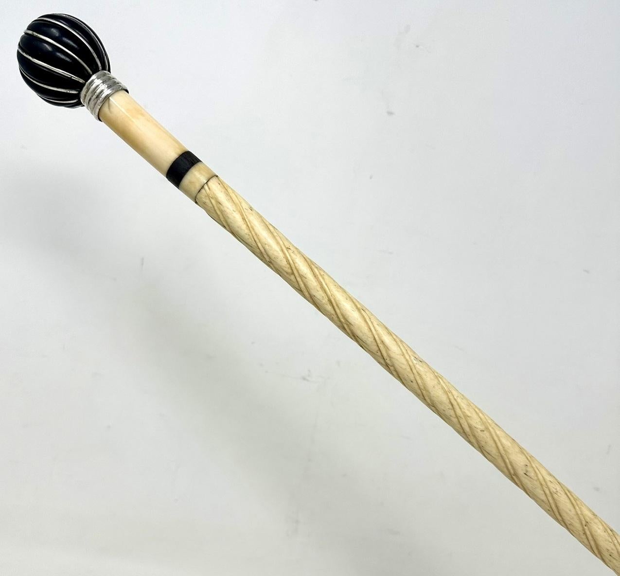 A Very Fine & Rare Example of a Mariner’s Whale Bone Walking Cane of exceptional quality. First half of the Nineteenth Century, possibly of English origin. 

The plain ball grip with wirework detailing above a four-ring silver band on a tapering