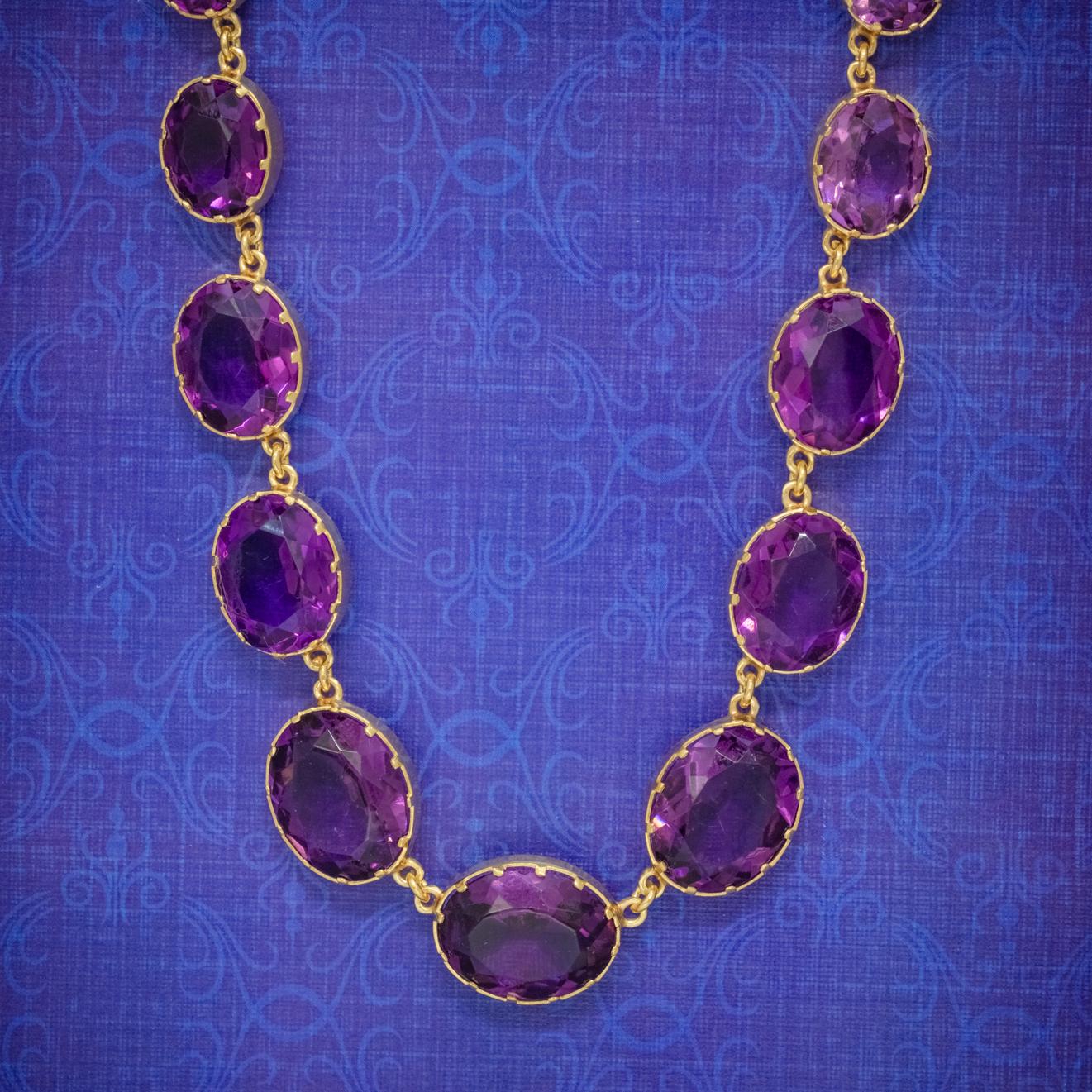 A regal Antique Victorian necklace made up of large Paste Stone links which have a striking deep violet hue and graduate in size from a 2.5ct stone at the clasp to an 8ct at the bottom. 

Paste is a transparent flint glass that simulates the fire
