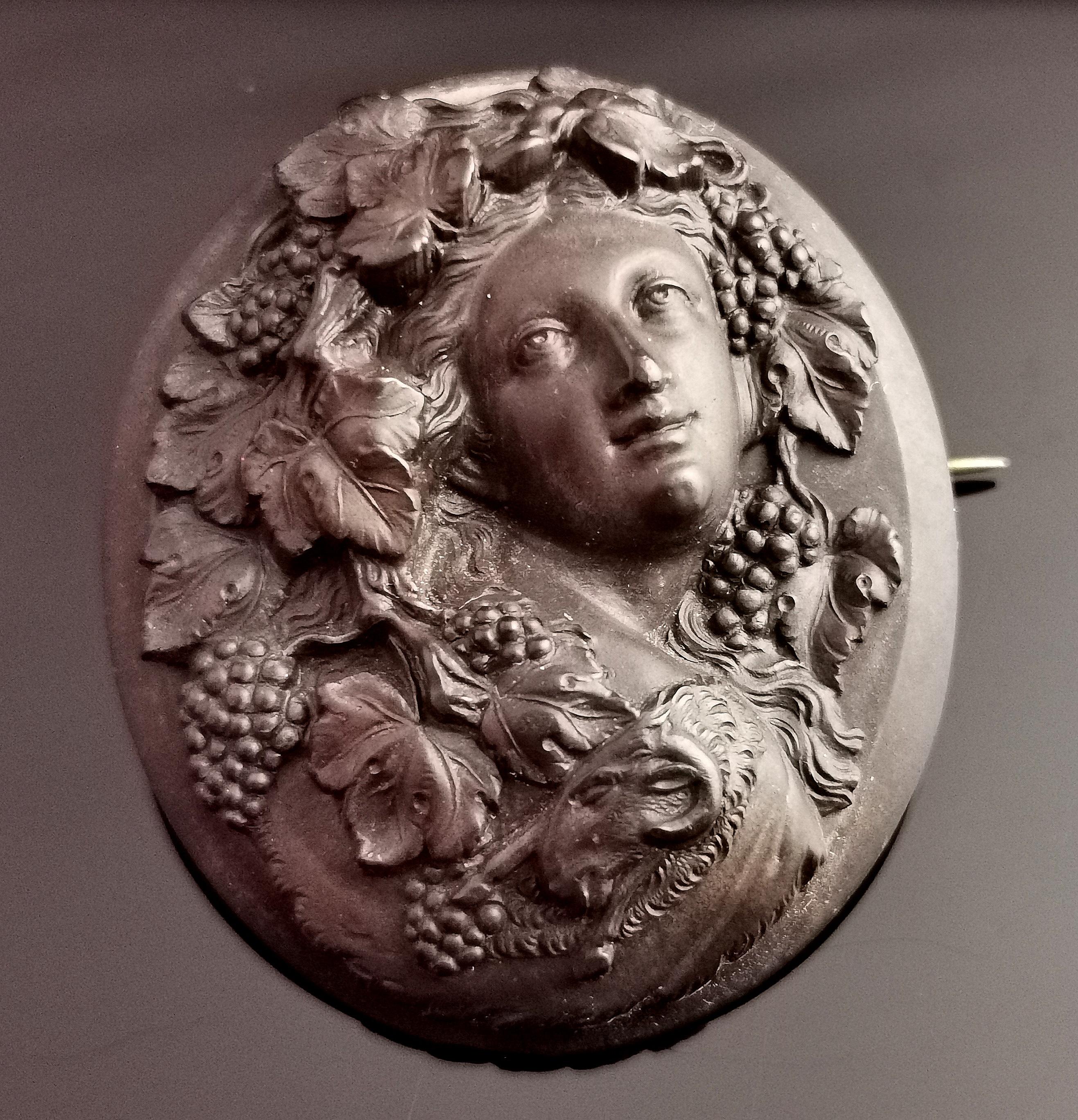A beautiful antique Victorian Vulcanite cameo brooch.

It is a very finely designed brooch in high relief featuring the bust of a Bacchante.

Bacchante were considered to be the female followers of the Roman god of wine Bacchus.

This is a highly