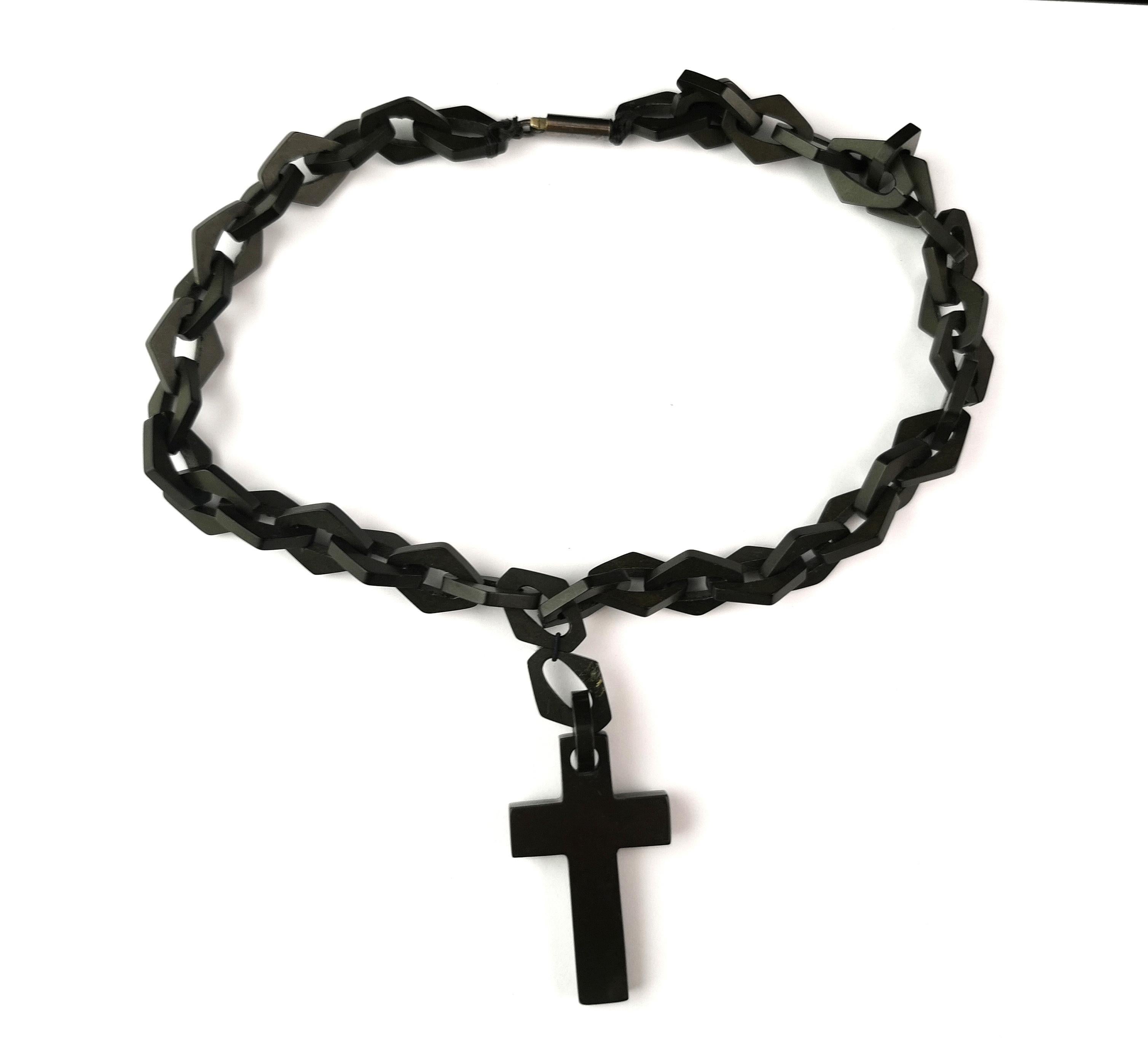 An attractive and unusual antique Victorian Vulcanite Cross and chain necklace.

The necklace features large, chunky, fancy mariner style Links, interlocking along the length and it fastens with a barrel clasp which is a later addition.

The cross