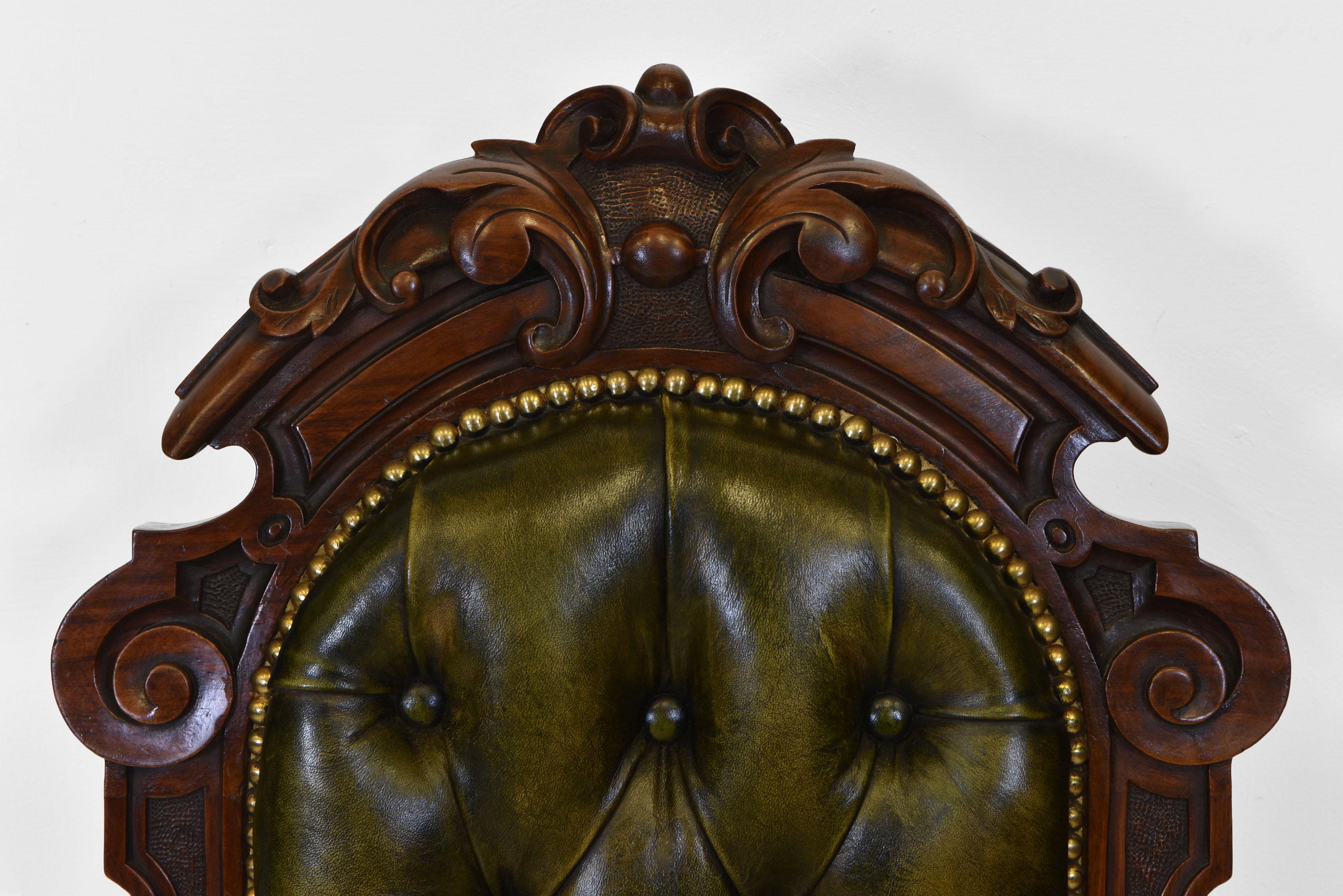 A Victorian walnut framed & green leather button side chair, sitting on brass and white porcelain castors. Circa 1860.

The chair is of good quality, with carved decoration to the top rail and shaped frieze, and terminating on carved cabriole