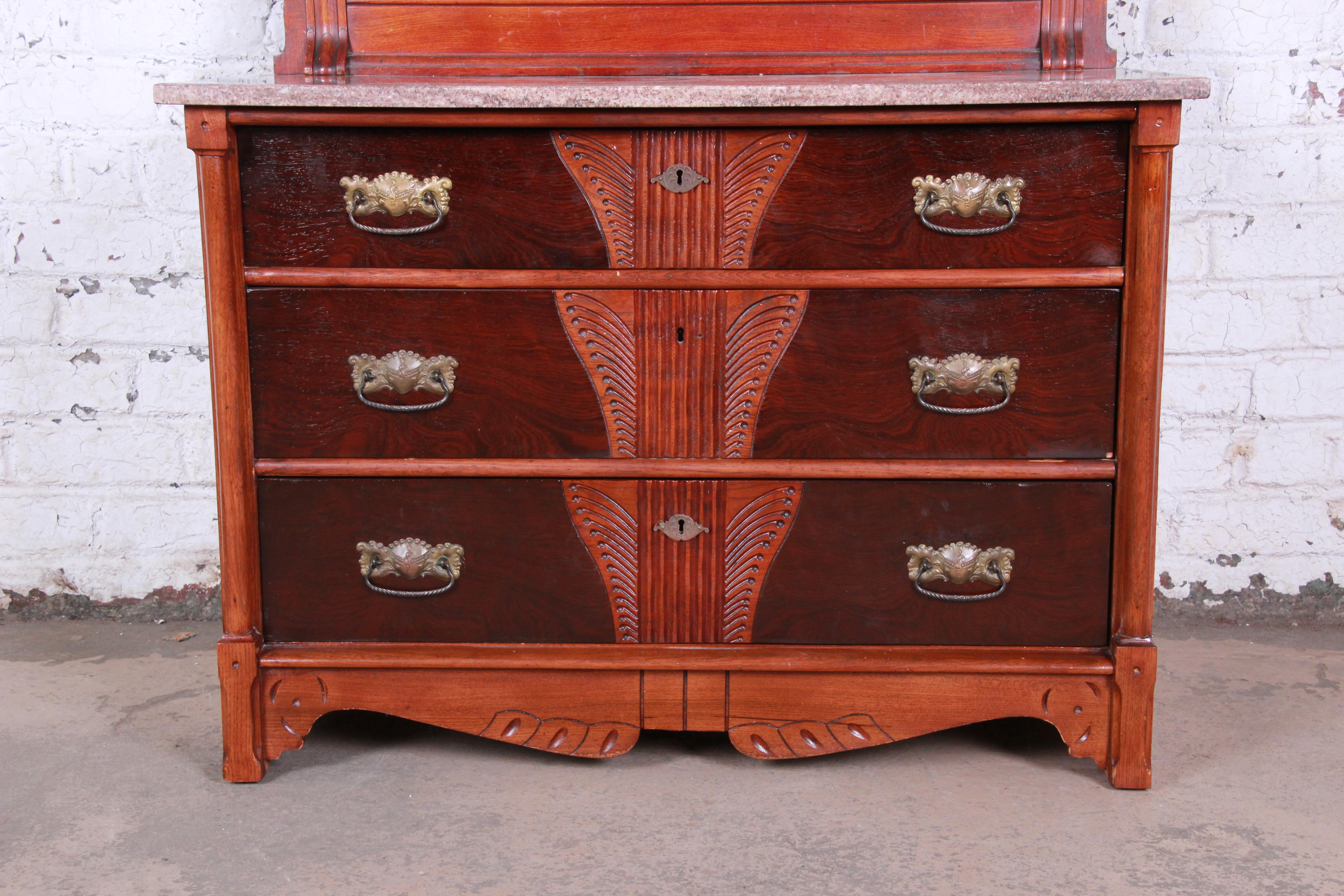 A gorgeous 19th century Victorian carved walnut and rosewood marble top dresser with mirror. The dresser features beautiful carved wood details, with solid walnut construction and stunning rosewood drawer fronts. It has a nice beveled marble top, as