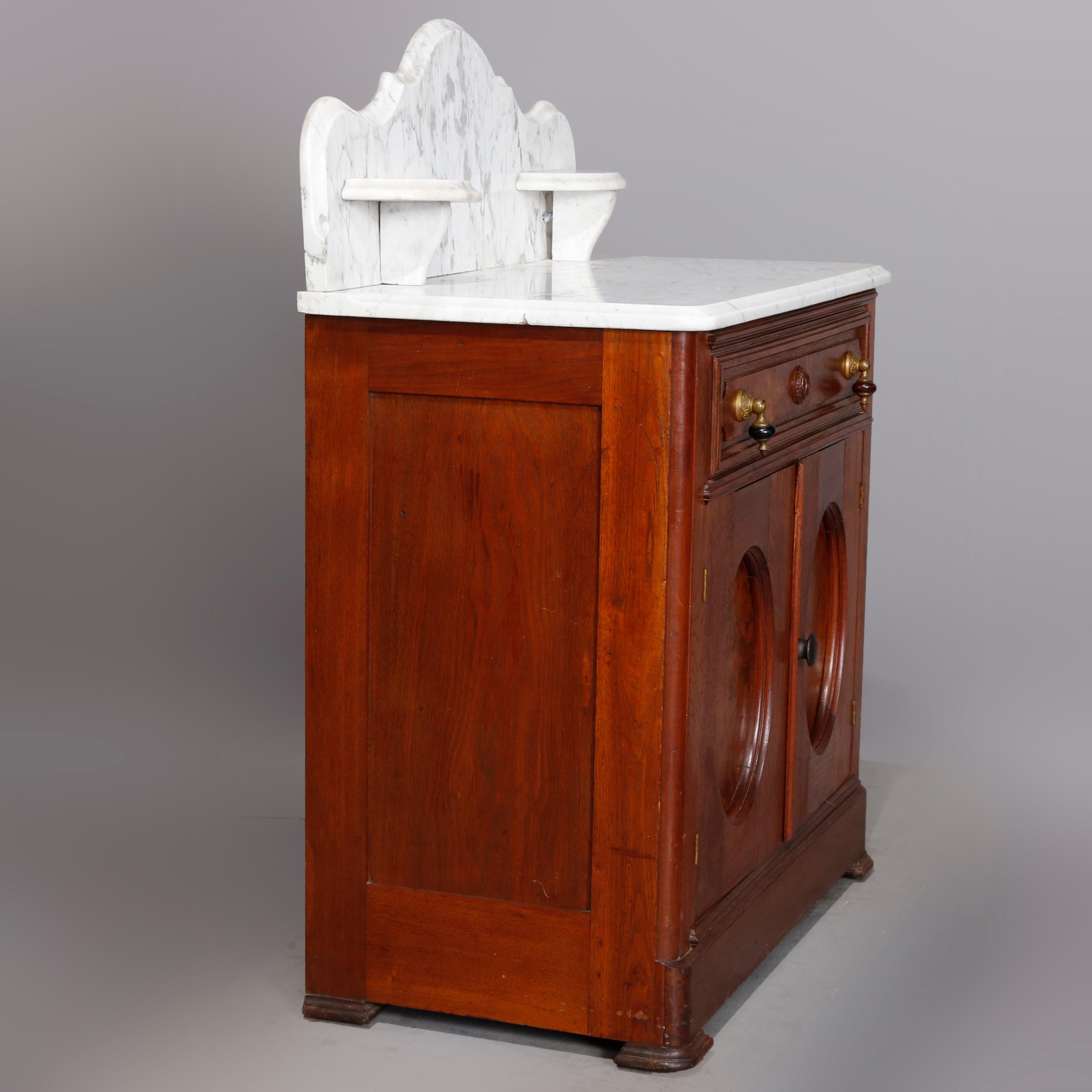 An antique Victorian washstand offers beveled marble-top with shaped backsplash having candle stands surmounting walnut and burl case with frieze drawer and double door lower cabinet, circa 1880

***DELIVERY NOTICE – Due to COVID-19 we are employing