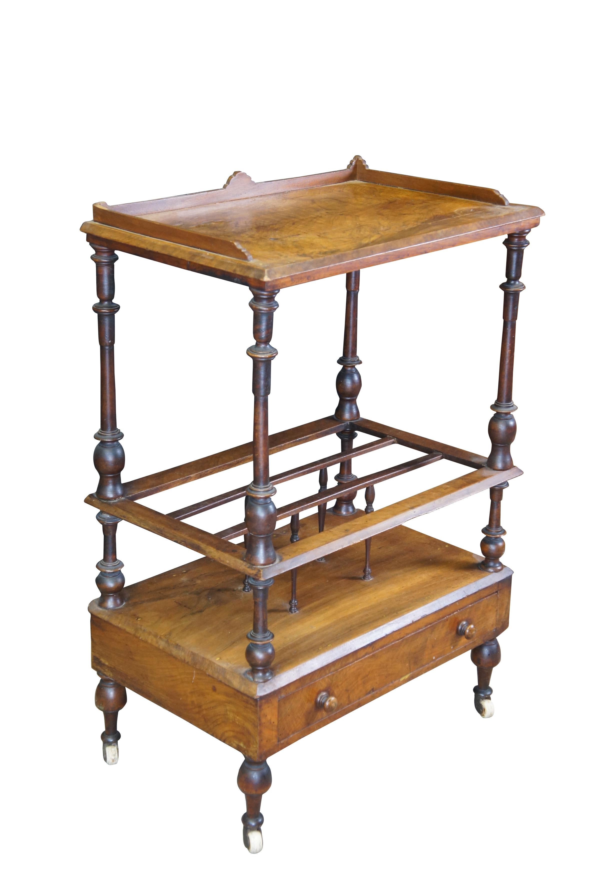 Antique Victorian walnut Canterbury rack / cart.  Made of walnut featuring fruitwood inlay and gallery, supported on finely turned columns, the middle section having three divisions which are divided with turned spindles, with a nice moulded edge
