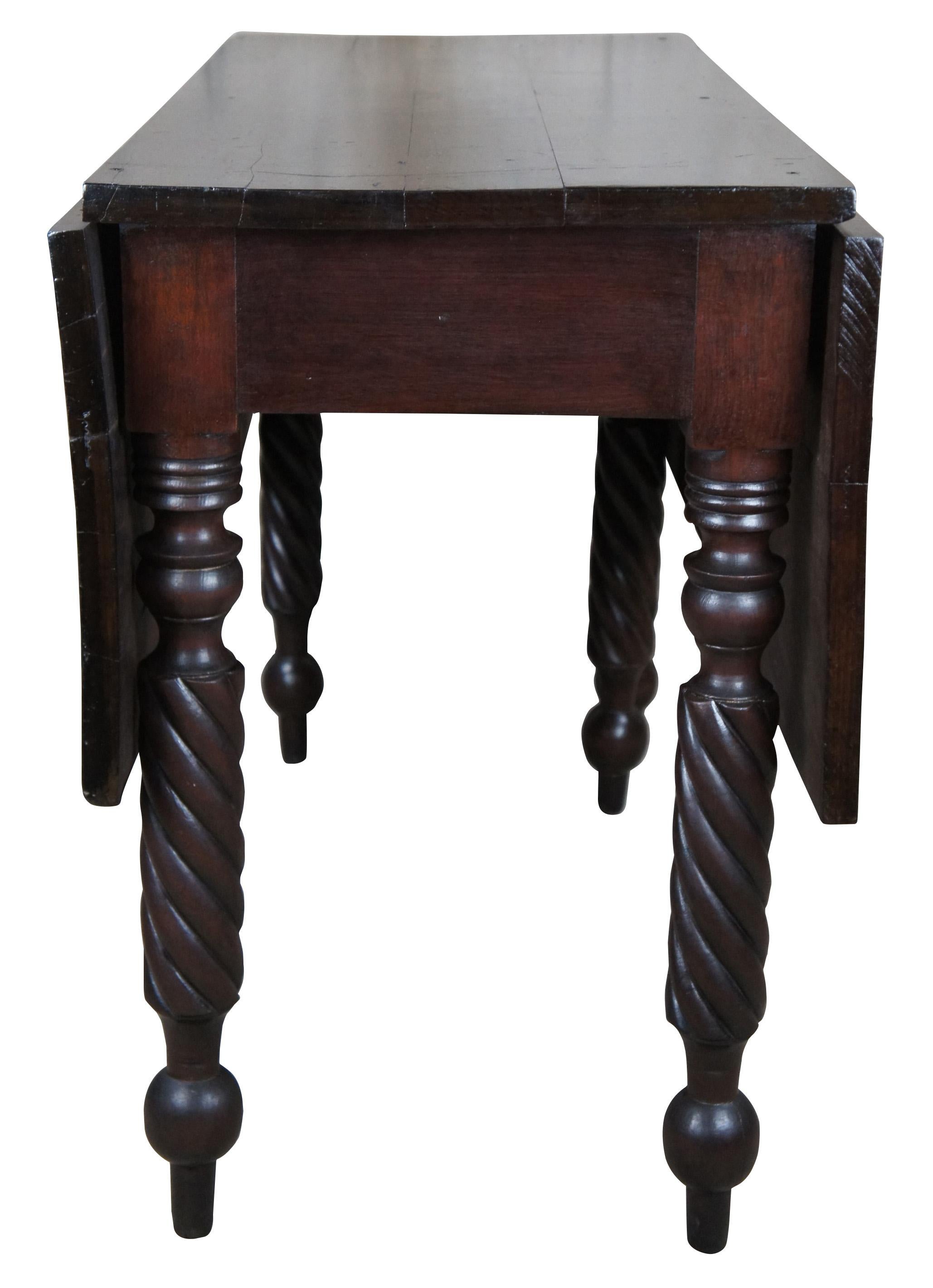 Antique 19th century dropleaf gateleg console or dining table. Made of walnut featuring two leaves with turned barley twisted legs.

Measures: 44.5