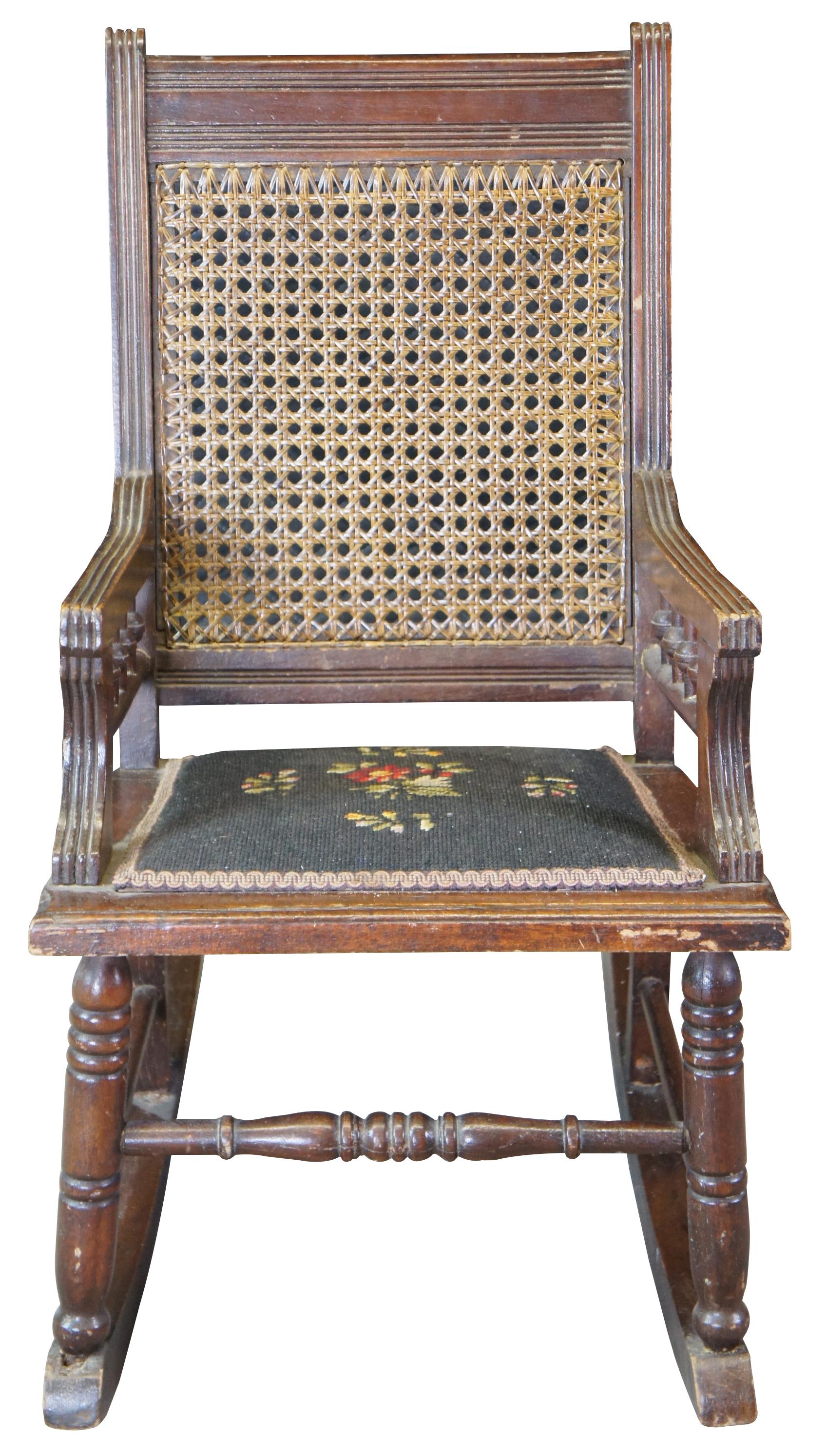 Antique Victorian Eastlake childs rocker featuring caned and needlepoint design with turned and fluted accents.
 