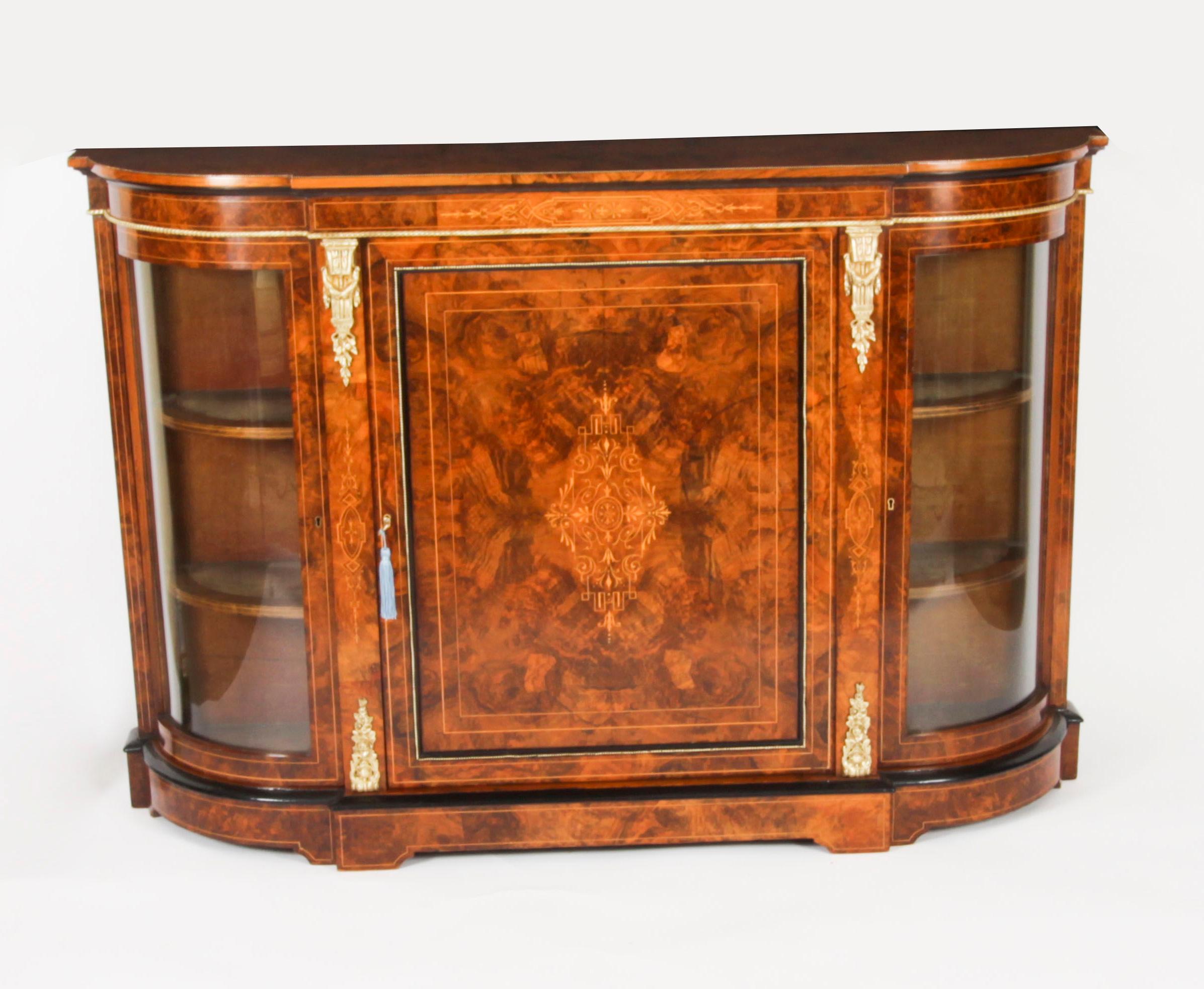 This is an exceptional quality  antique Victorian ormolu mounted burr walnut, ebonised  and marquetry inlaid scredenza, circa 1860 in date.

The entire piece highlights the unique and truly exceptional pattern of the book matched burr walnut veneers