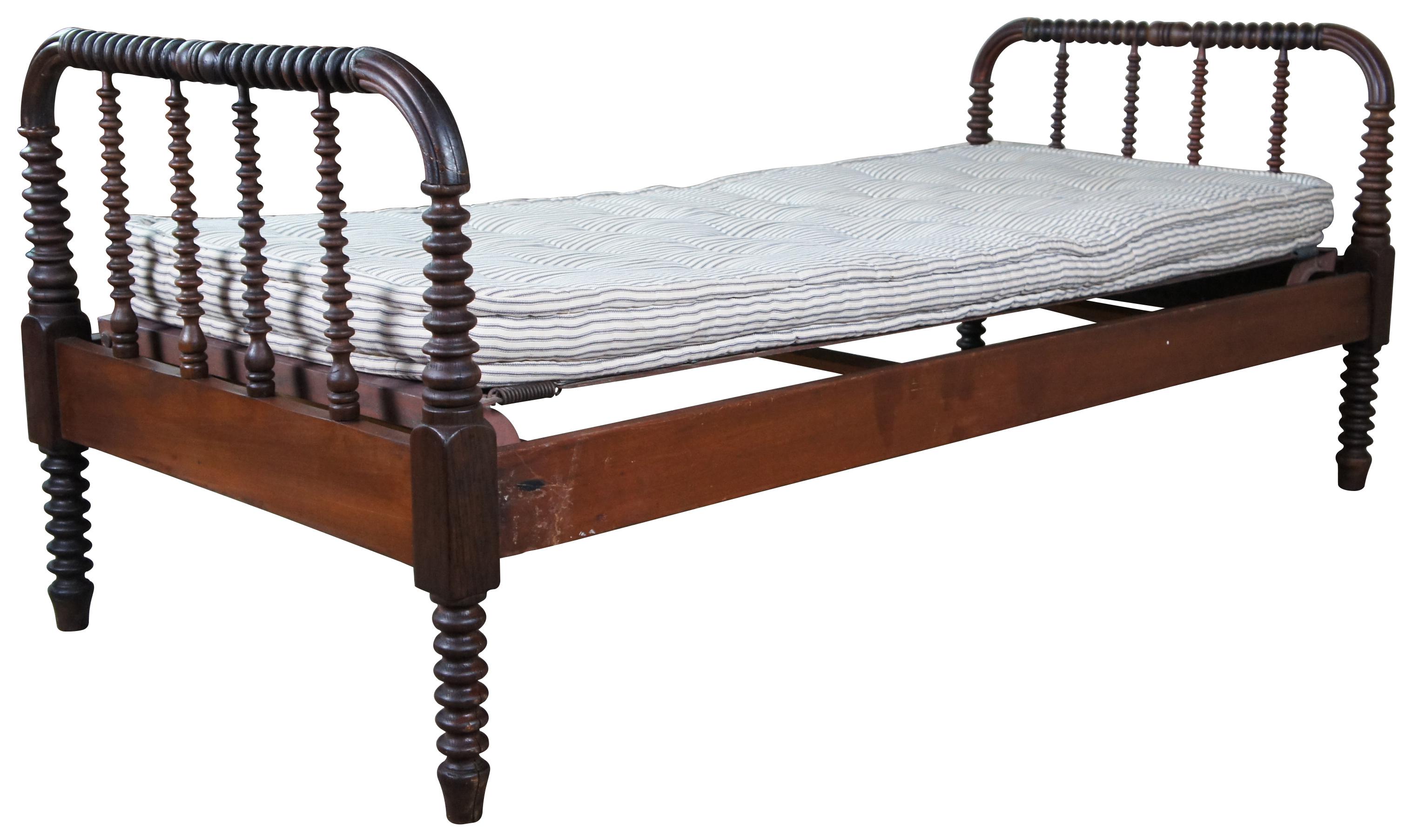 American country bed jenny lind bed. Made from walnut with spool turned posts and spindles. Includes custom springs and mattress.

Measures: 34.5