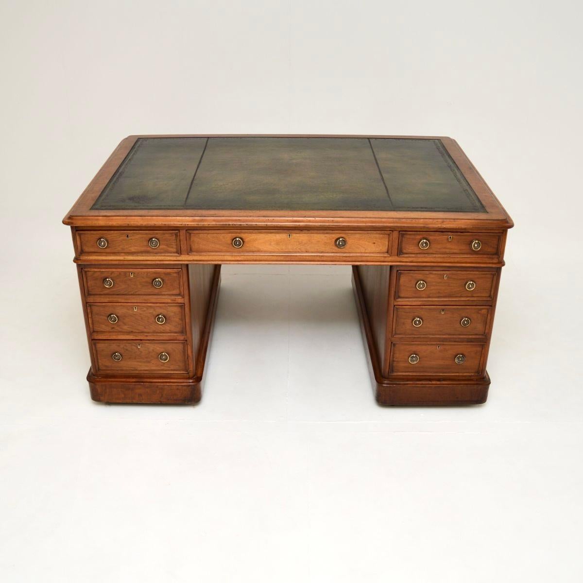 A magnificent antique Victorian walnut leather top partners desk. This was made in England, it dates from around the 1860-1880 period.

It is of extremely high quality, and is a large and impressive piece. The front has lots of drawers and storage