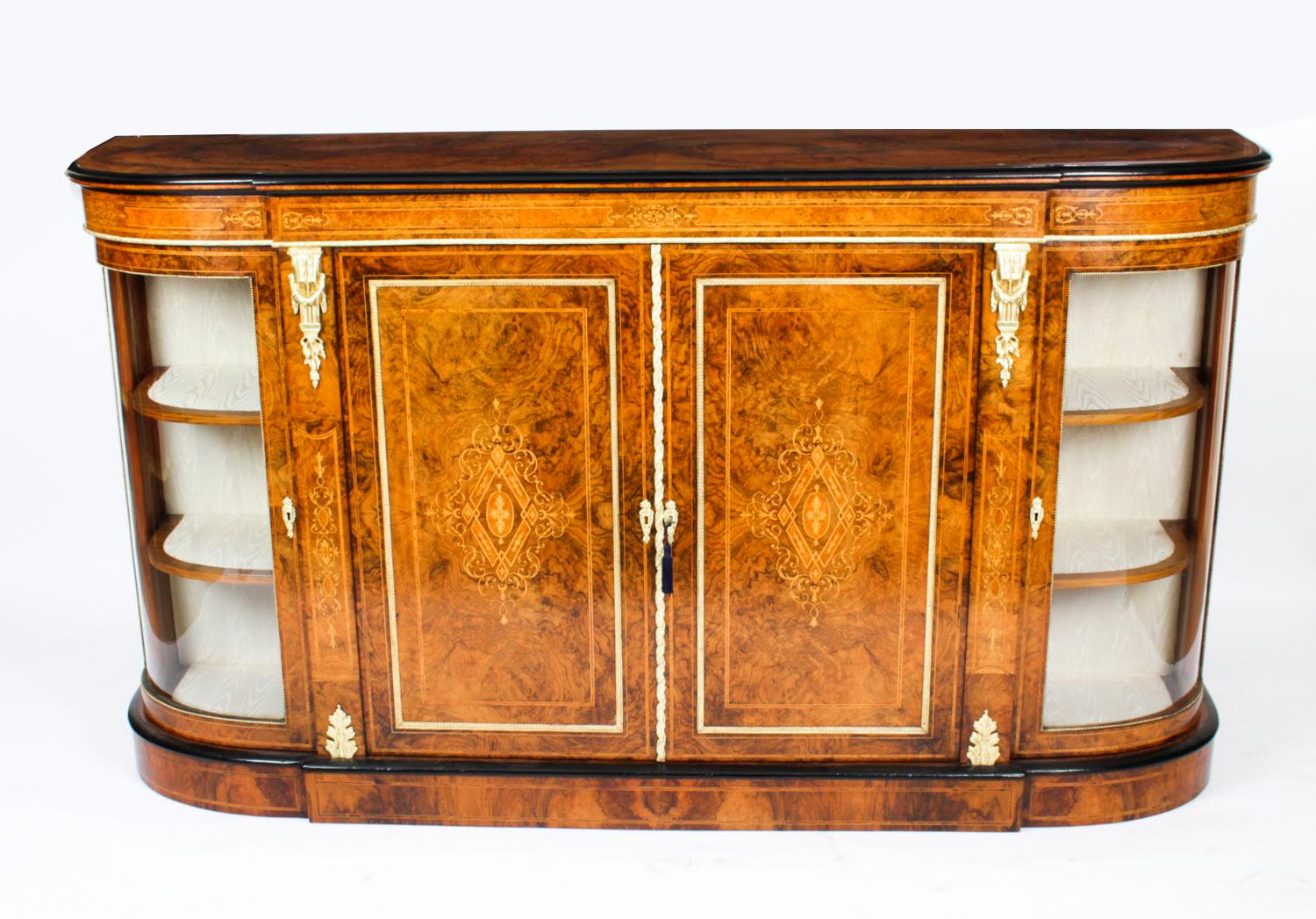 This is a stunning antique Victorian burr walnut, marquetry inlaid and ormolu mounted credenza, circa 1880 in date.

The entire piece highlights the unique and truly exceptional pattern of the burr walnut extremely well and the walnut is