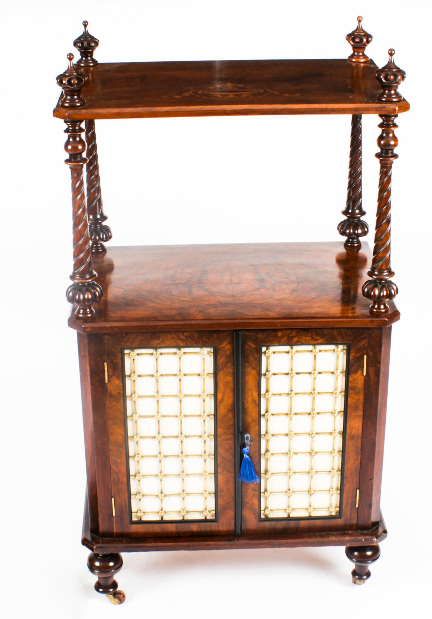 This is a beautiful antique Victorian burr walnut and inlaid music cabinet, Circa 1860 in date.

The inlaid upper tier is supported by turned and carved walnut columns. The music cupboard with a pair of doors opening to reveal shelves. The door