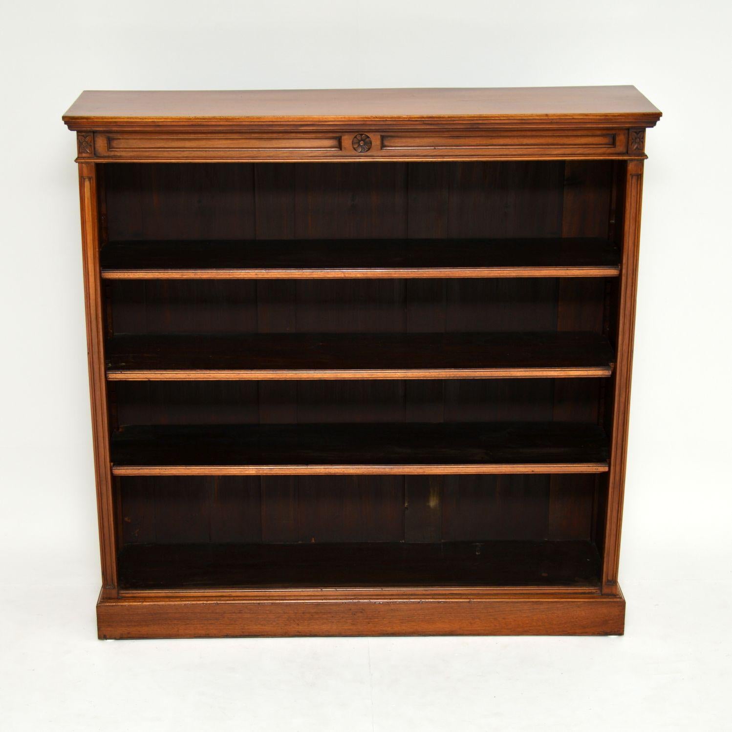 This antique solid walnut open bookcase is fairly large, so will hold a lot of books.

It’s late Victorian, dating to around the 1880s period and is in very good original condition.

This bookcase has a panelled top and sides, with some carved
