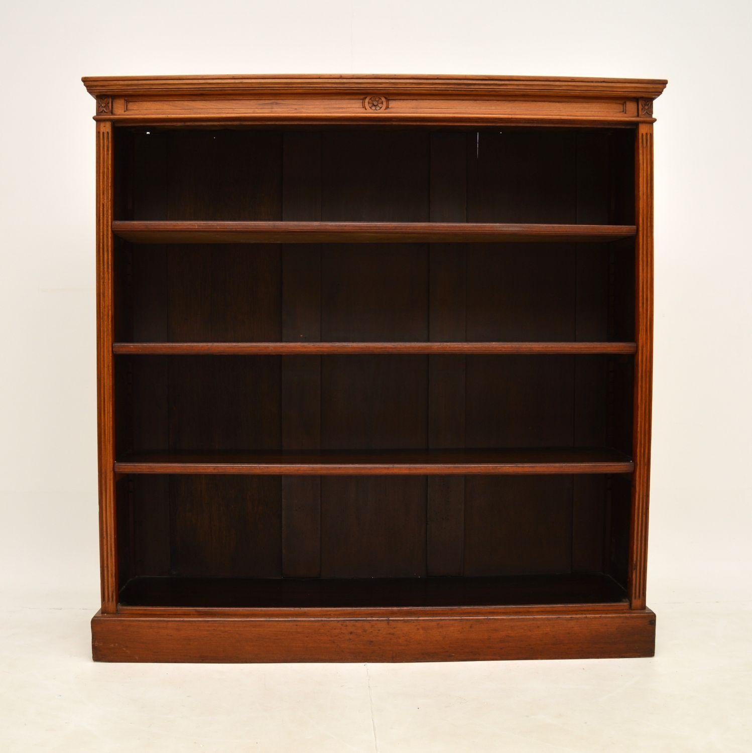 A beautiful and useful Victorian open bookcase in solid walnut, made in England & dating from around the 1860-1880 period.

It is of fine quality, with lovely floral carving on the corners, the front edges are reeded and this sits on a plinth