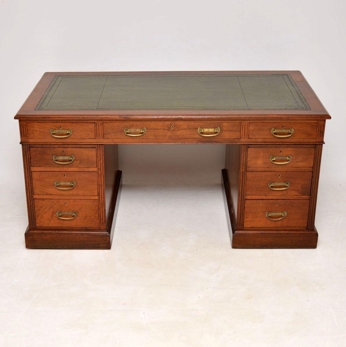 Large antique Victorian walnut pedestal desk with a tooled leather writing surface, a polished paneled back & sitting on plinth bases. It’s in very good condition, having just been French polished & dates to circa 1880s period. All the drawers have