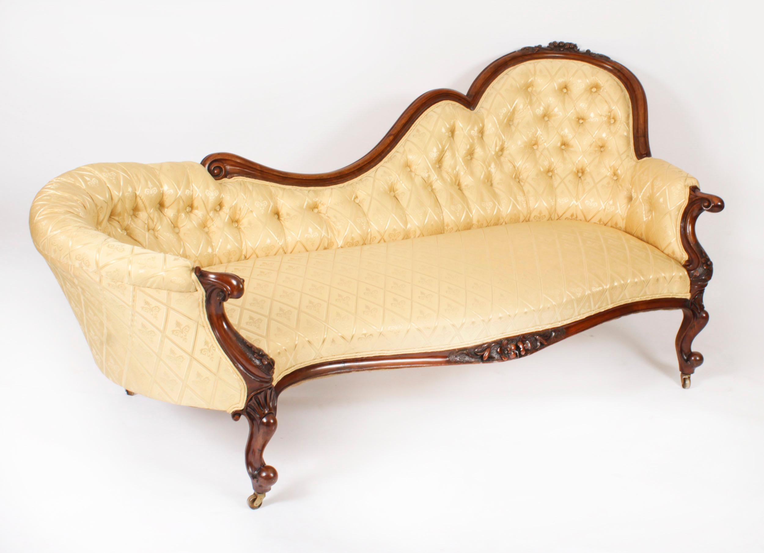 This is a fantastic antique Victorian chaise longue which dates from Circa 1860.

This sofa was made from hand carved solid walnut with carved floral decoration and stands on elegant carved cabriole legs which terminate in their original brass and