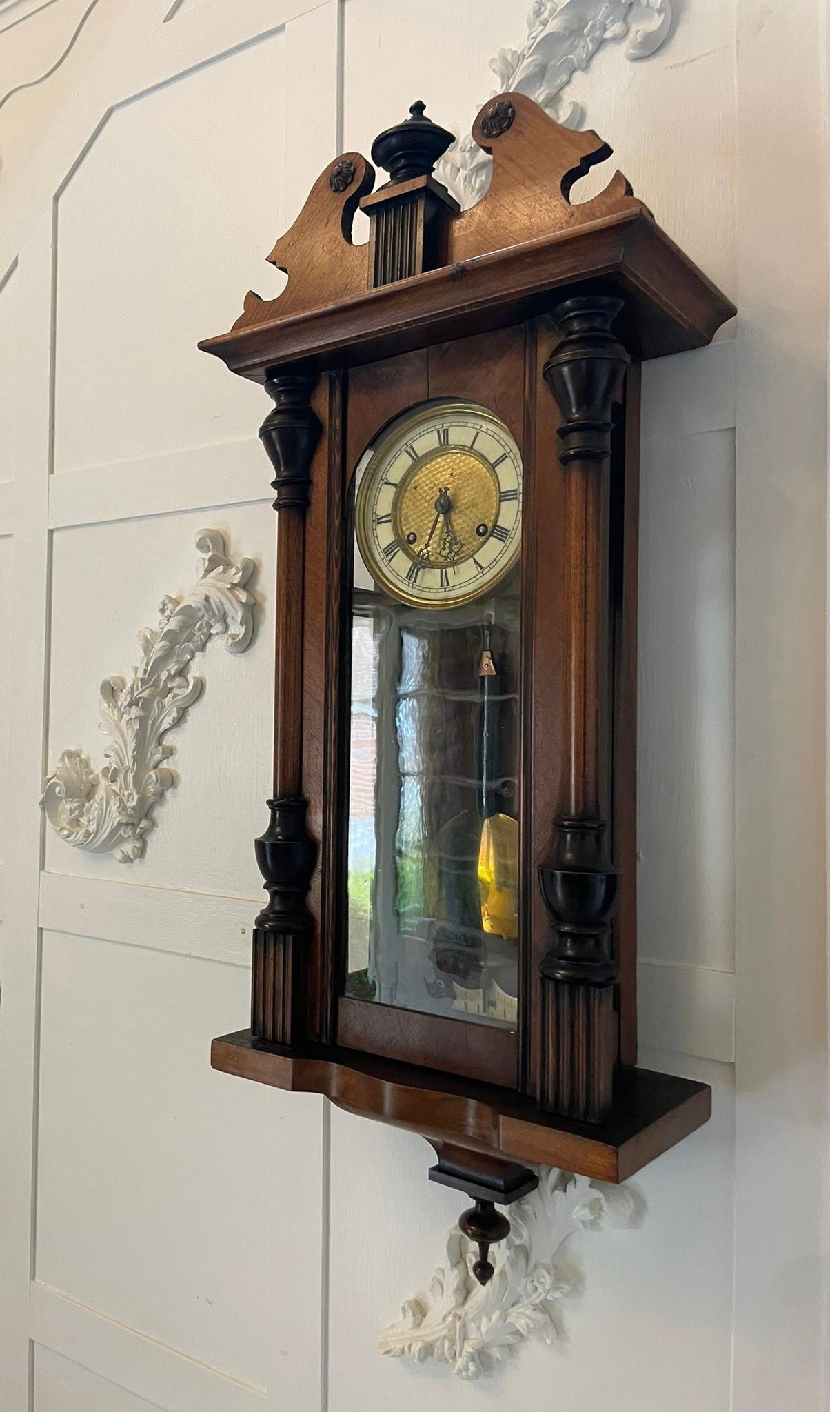 Antique Victorian walnut Vienna wall clock having a shaped swan neck top and a superb quality walnut case with turned columns and original finals, eight day striking movement on the hour and half hour on a gong, round dial with original hands and
