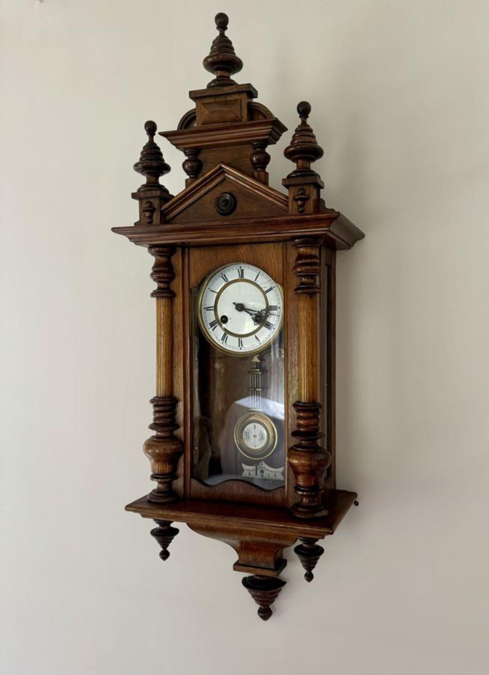 Antique Victorian walnut Vienna wall clock, having a quality walnut case with fantastic carved columns, the original turned finials to the top and bottom, a single glazed door to the front and a circular porcelain dial, the original hands, with an 8