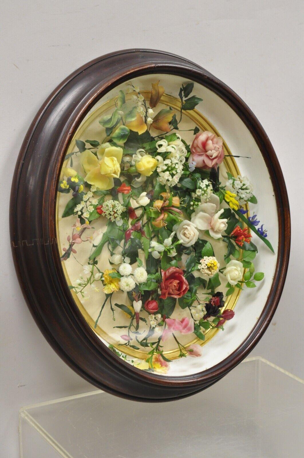Antique Victorian Wax Floral Mourning Wreath Oval Mahogany Shadow Box Oddity. Colorful wax flower arrangement, oval mahogany shadowbox wood frame, gold gilt interior trim, glass front, very nice antique item. Circa 19th Century. Measurements: 19.5