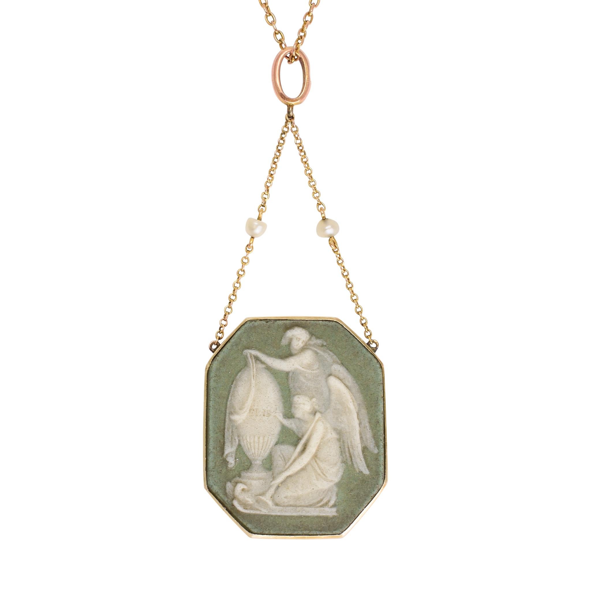 A gorgeous Victorian Wedgwood cameo necklace dating from the 1870s. The colour of the cameo is unusual, a slate grey background with the classic white subject, and it depicts two angels and an urn: one is dressing th urn with a mourning shawl, and