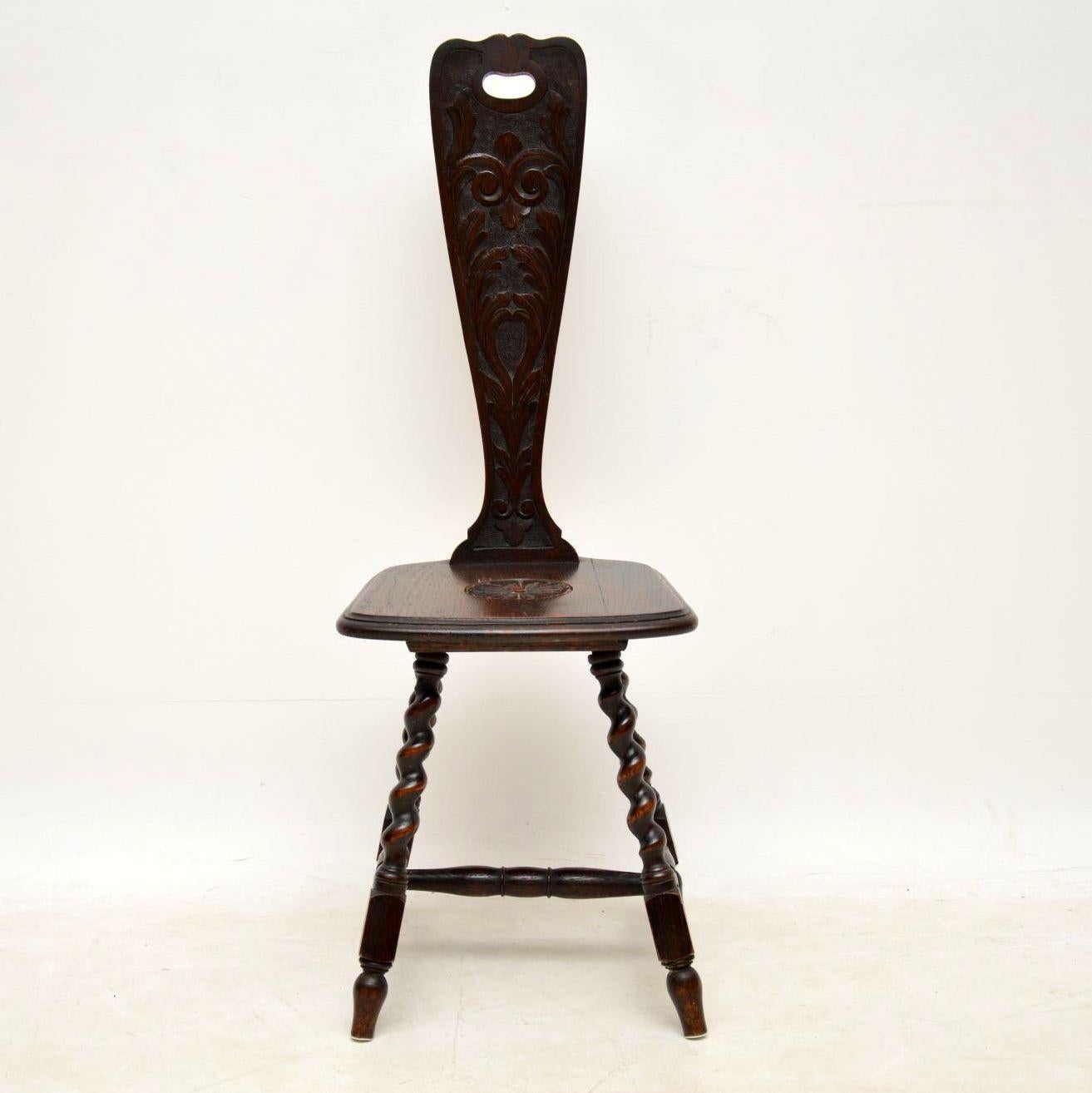 Antique Victorian welsh oak spinning chair, which I believe is so named because they used to sit on these chairs when using a spinning wheel. This one is solid oak, carved on the back & seat, with turned barley twist legs joined by cross stretchers.