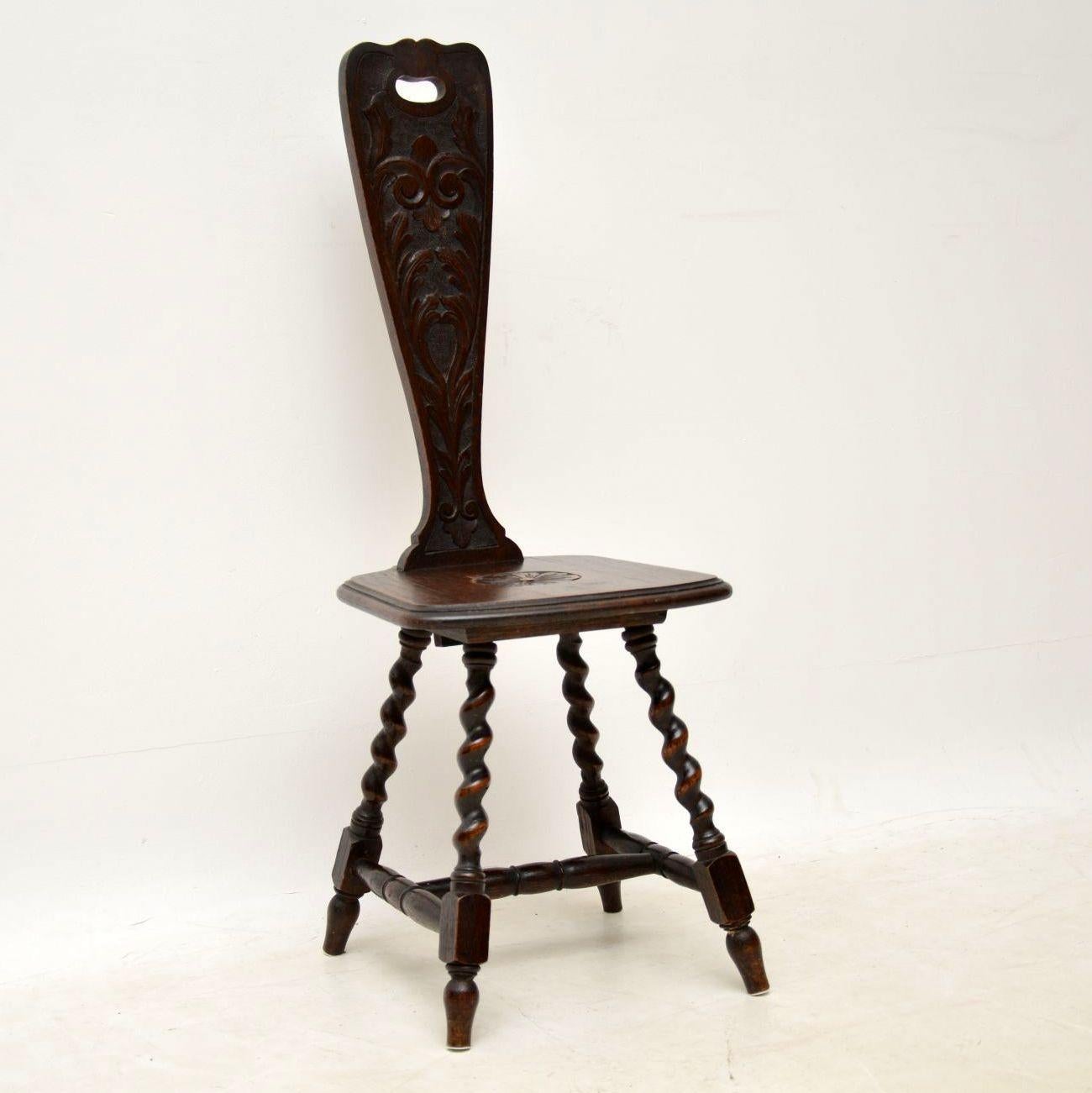 Antique Victorian Welsh oak spinning chair, which I believe is so named because they used to sit on these chairs when using a spinning wheel. This one is solid oak, carved on the back & seat, with turned barley twist legs joined by cross stretchers.