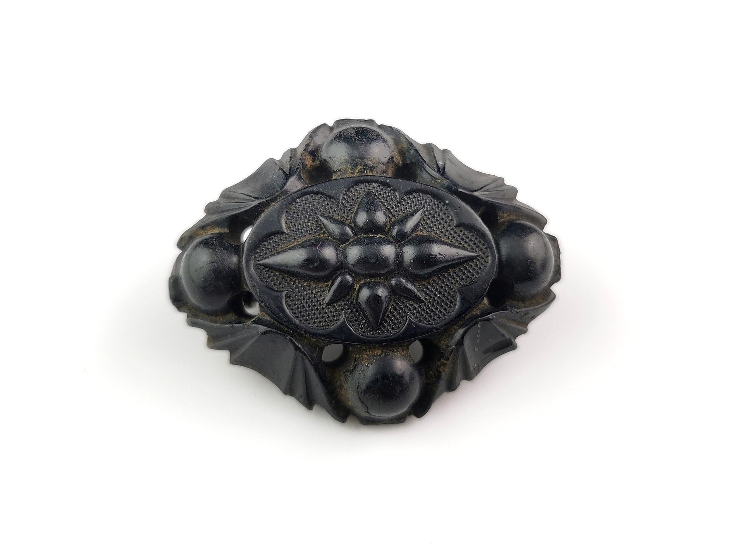 A gorgeous antique Victorian era Whitby Jet brooch.

It is a diamond shaped brooch with rounded corners and an engraved centre with a star shape carved into the middle.

It has four rounded beads to each corner.

A very attractive brooch.

Whitby