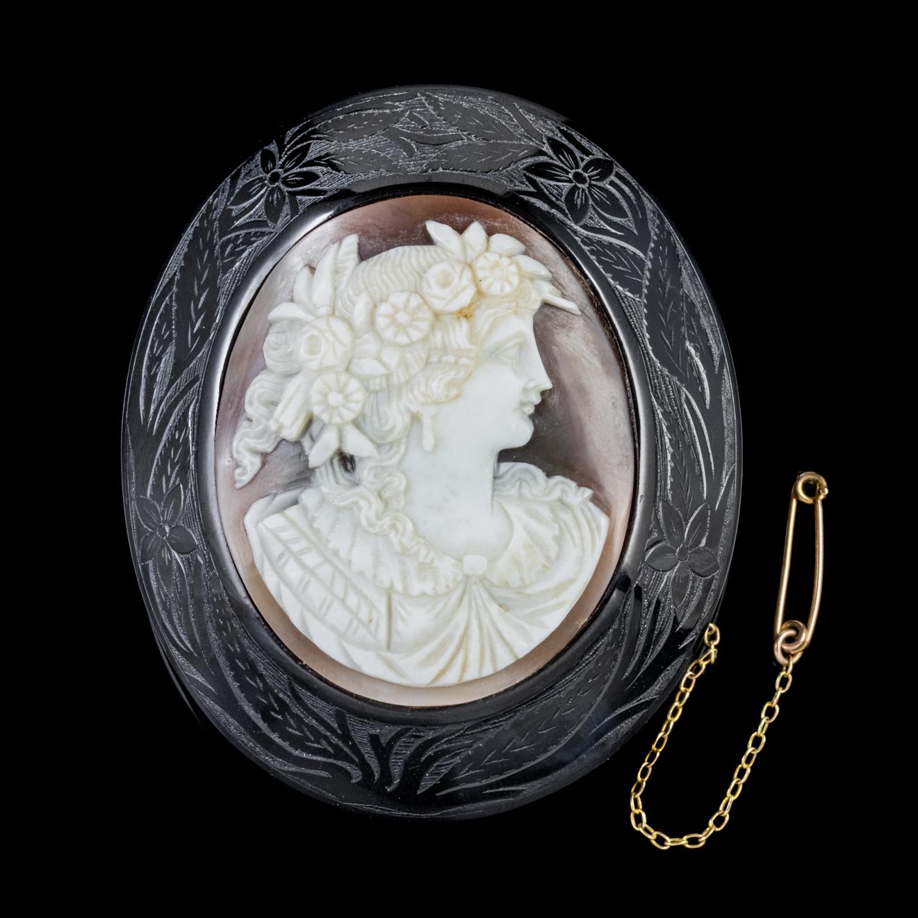 An exquisite Antique Cameo brooch dating from the mid-Victorian era, Circa 1860. The Cameo depicts the side profile of an elegant lady with flowers woven into her long ringlets. It has been hand carved from Bullmouth Shell by an expert hand with