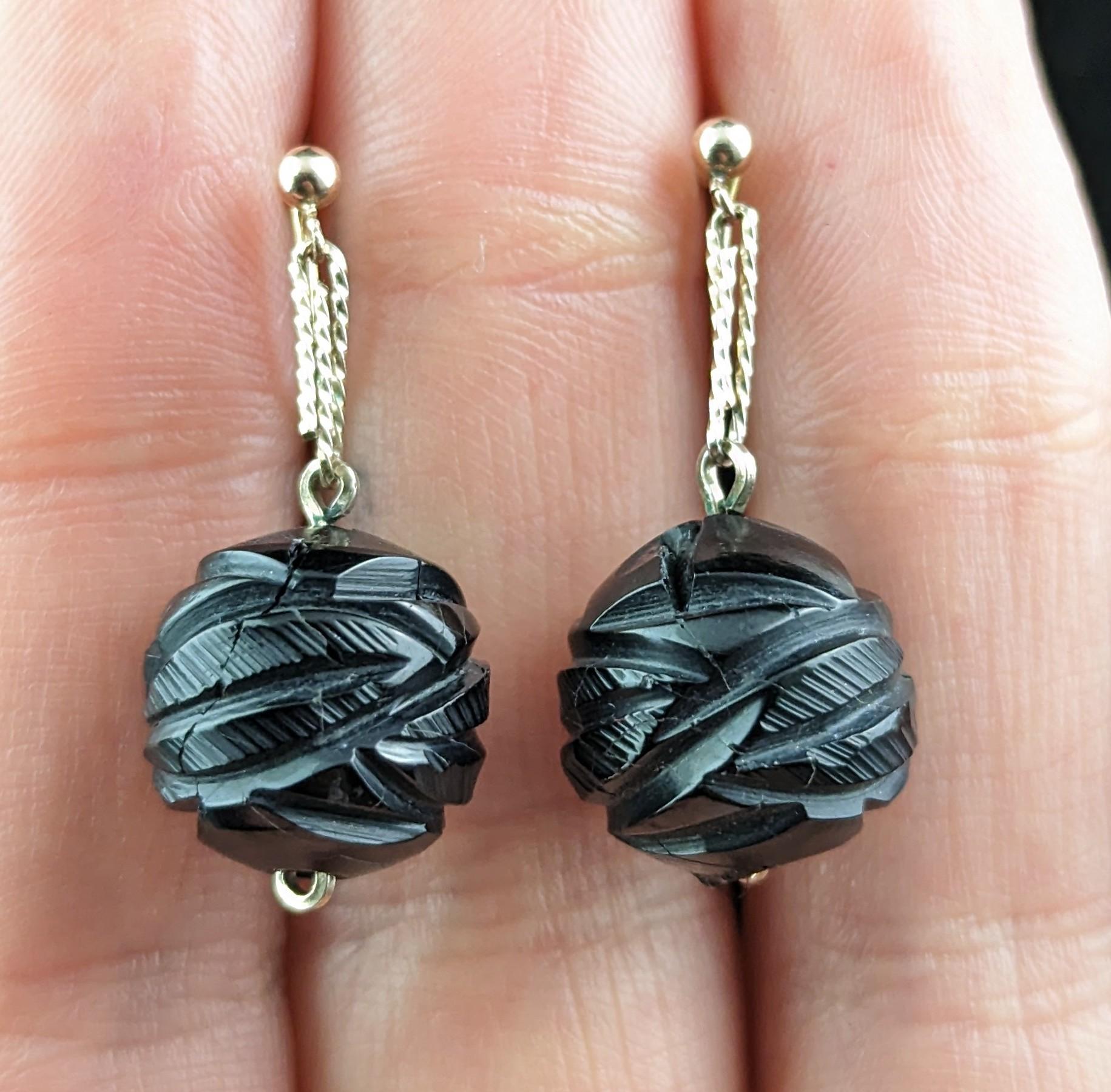 These delightful Victorian Whitby Jet earrings are delicate yet bold, a great addition to your antique earrings collection.

They are made from carved Whitby Jet, each earrings featuring a heavily carved large spherical bead, they are attached to a