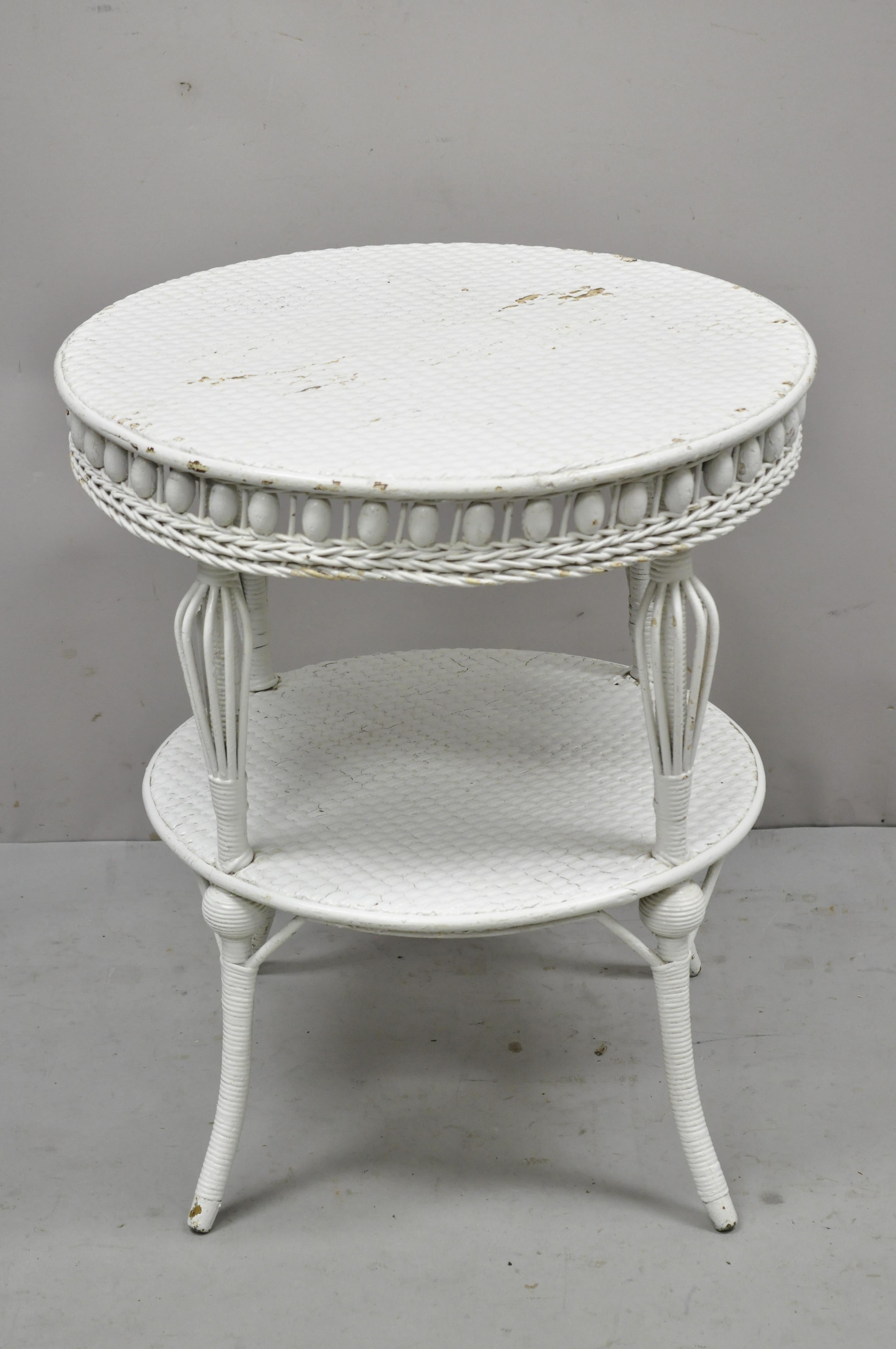 Antique Victorian White Wicker 2 Tier Round Accent Sunroom Parlor Lamp Table. Item features ornate skirt, 2 tiers, ball form accents, tapered legs, very nice antique item. Circa Early 1900s. Measurements: 25