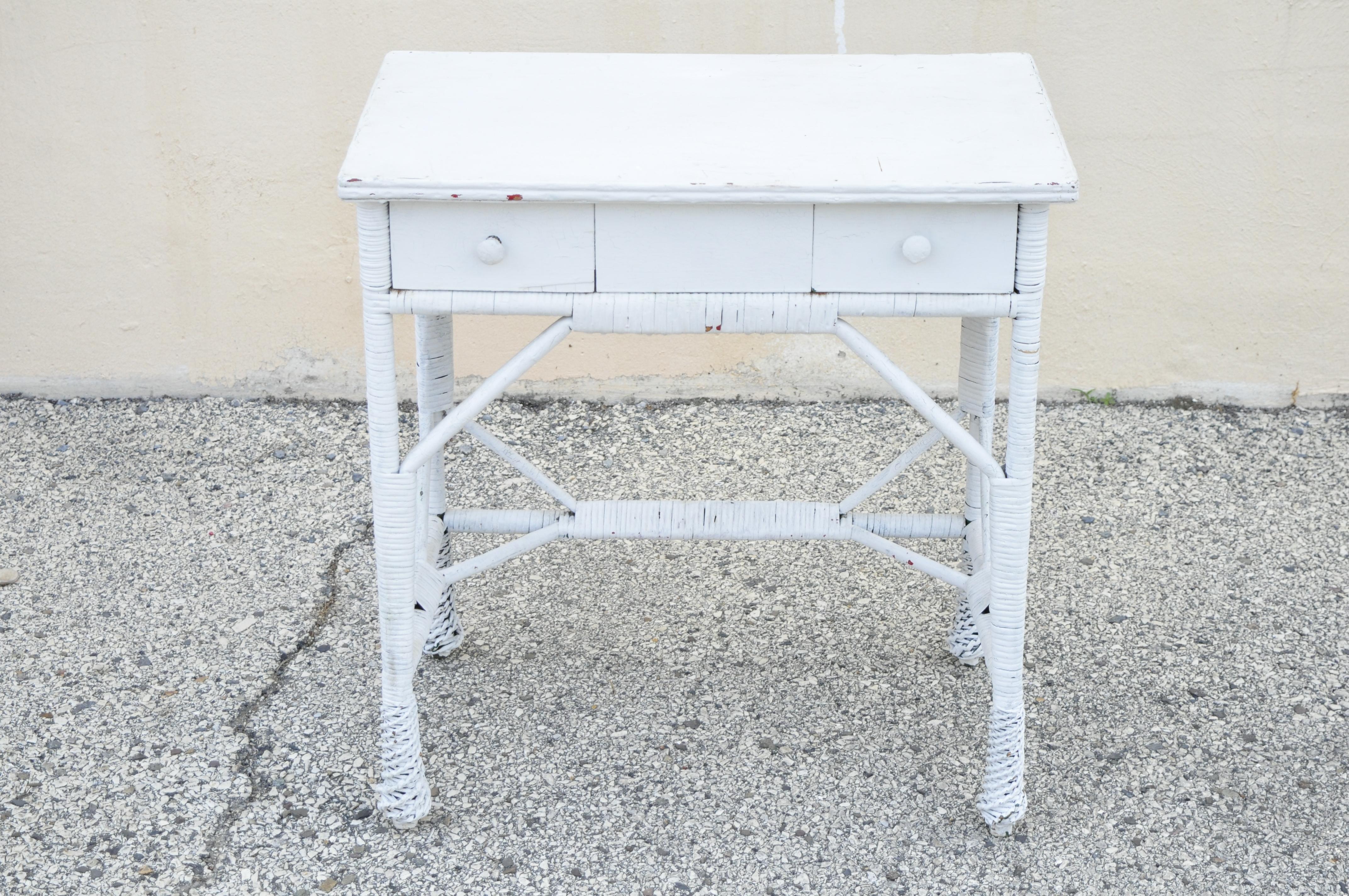 Antique Victorian white wicker rattan small vanity writing desk table 2 drawers. Item features nice petite size, 2 drawers, very nice antique item, quality American craftsmanship, great style and form. Circa Early 1900s. Measurements: 30