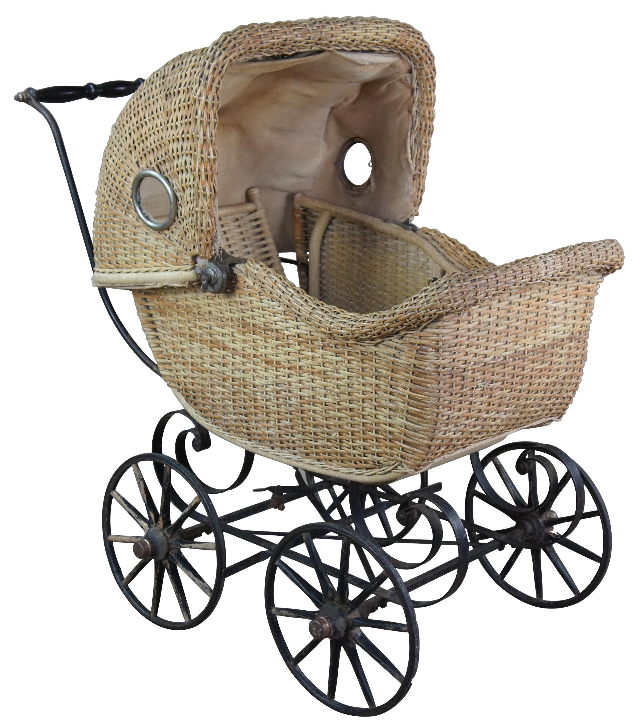 Antique wicker / rattan baby carriage, stroller or buggy. Features a hidden compartment below baby for storage.
 