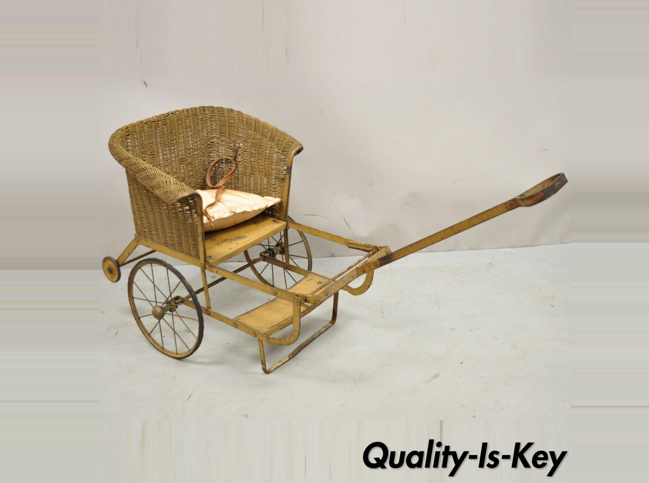 Antique Victorian Wicker & Metal Baby Carriage Pull Behind Stroller Dog Carrier. Item features a wicker seat, metal frame, leather straps, great for use as a dog carrier. Circa 1900. Measurements: 17