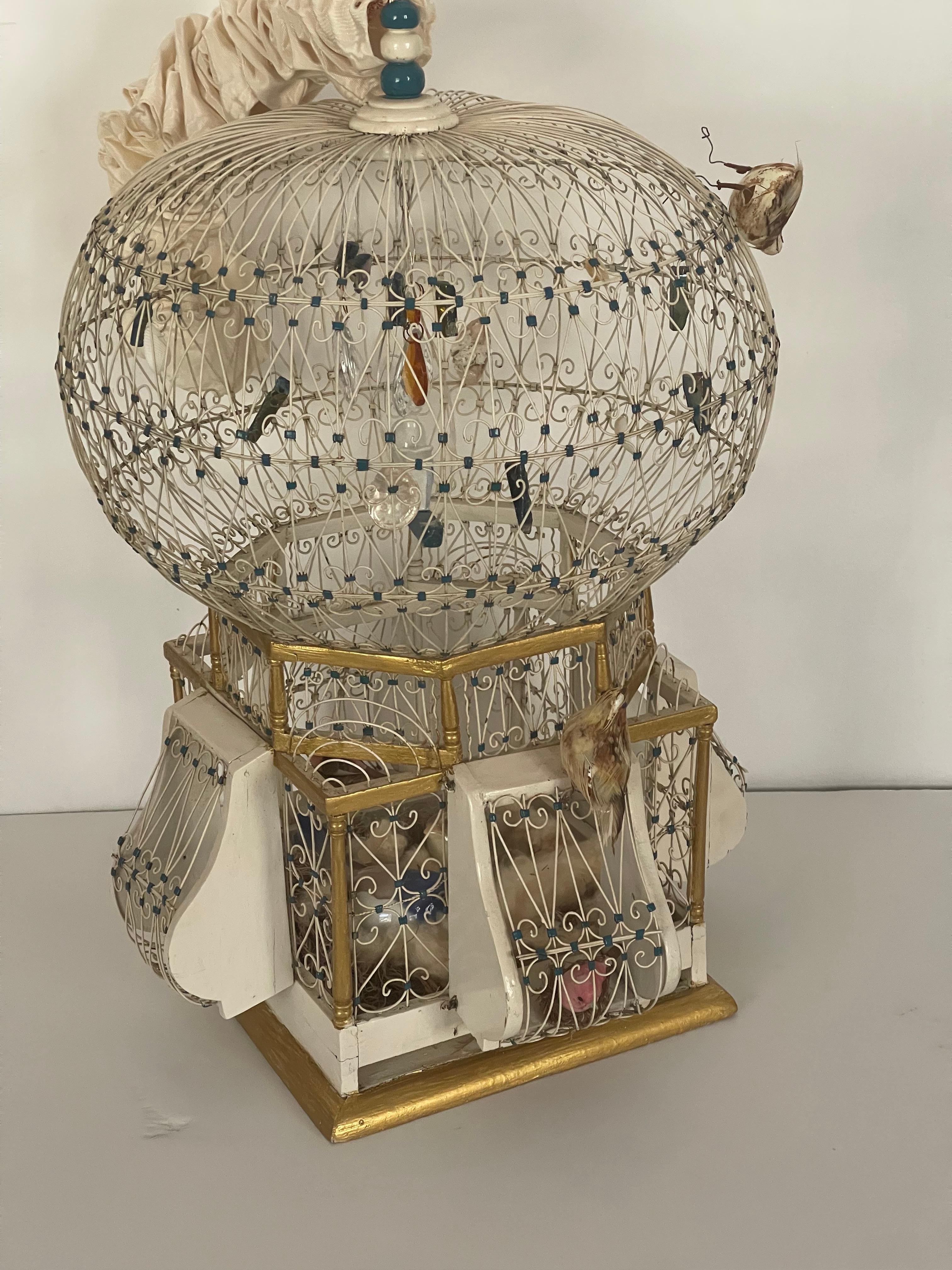 Antique Victorian domed wired bird cage with gold accents.