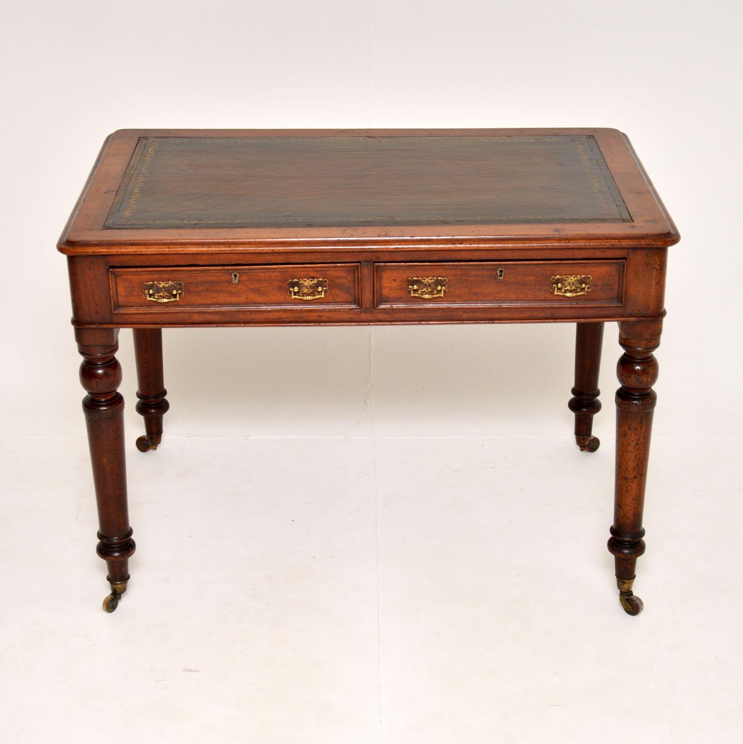 A fine antique Victorian period writing table in solid wood. This was made in England, it dates from around the 1860-1880 period.
It is of super quality and is of lovely proportions. There are beautifully turned solid wooden legs, brass handles and