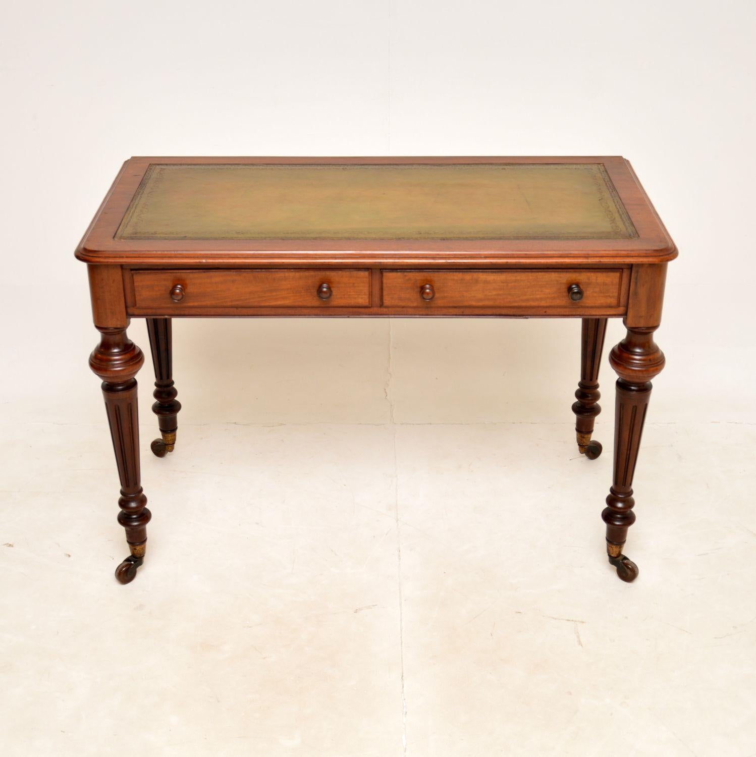 An excellent antique Victorian leather top writing desk. This was made in England, it dates from around the 1850-1870 period.

The quality is amazing, this sits on beautifully turned and fluted legs, terminating in porcelain casters. The drawers