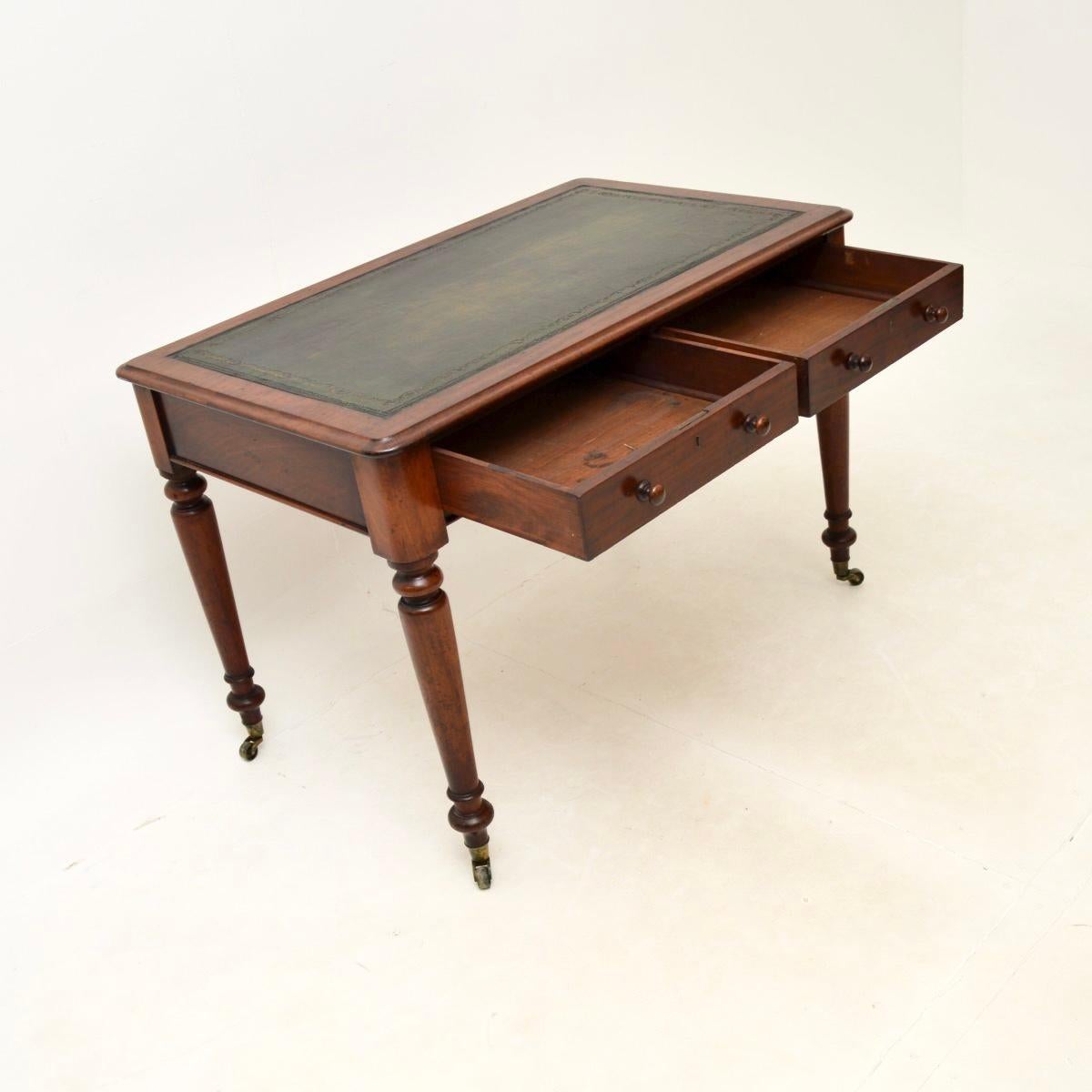A fantastic antique Victorian writing table / desk. This was made in England, it dates from around the 1860-1870 period.

It is of outstanding quality, it stands on beautifully turned legs with brass casters, the drawers have nicely turned handles