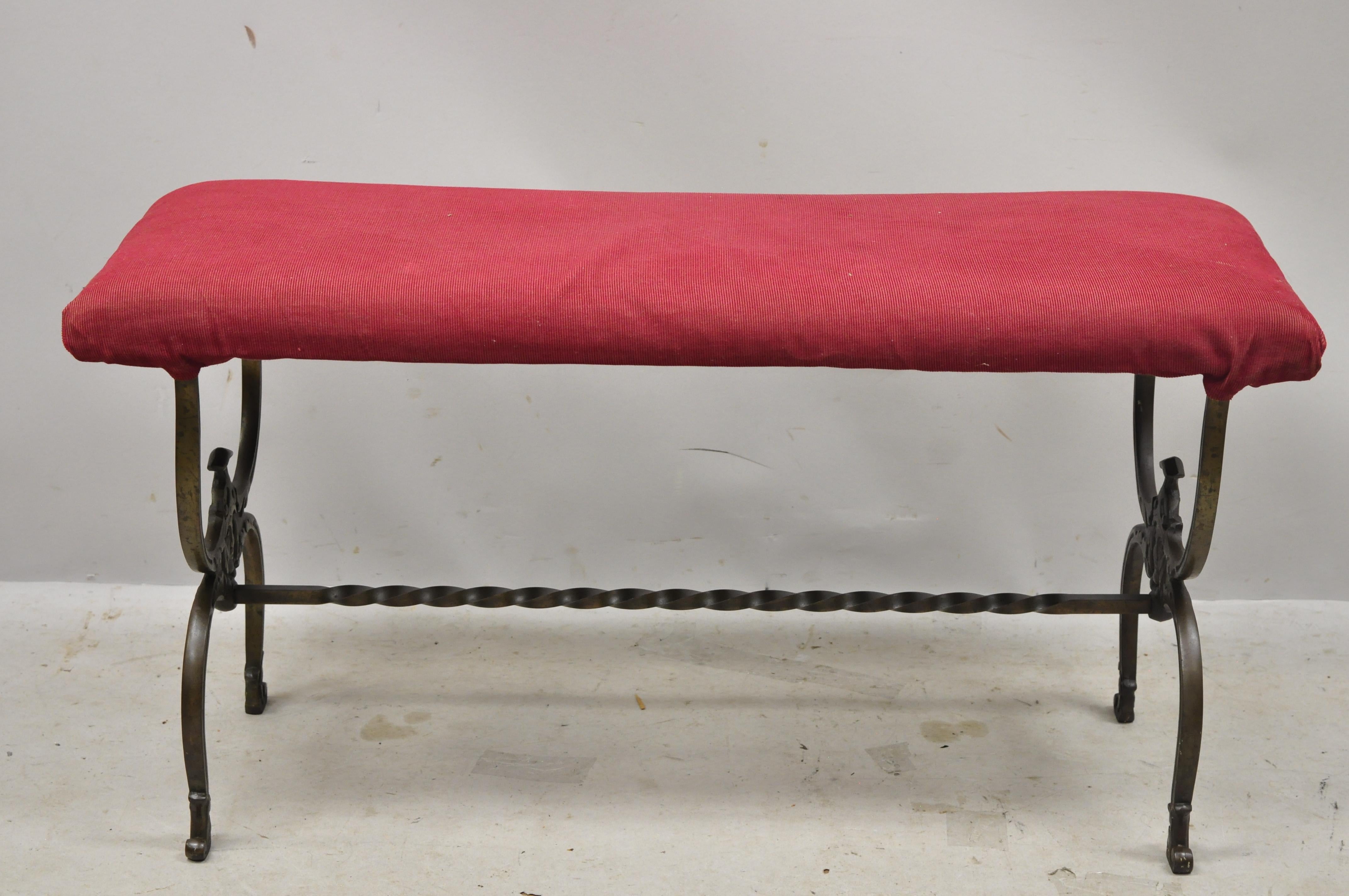Antique Victorian wrought iron figural bench with faces and twisted stretcher. Item features figural faces to base, spiral stretcher, wrought iron construction, upholstered seat, very nice antique item, circa late 19th century. Measurements: 18