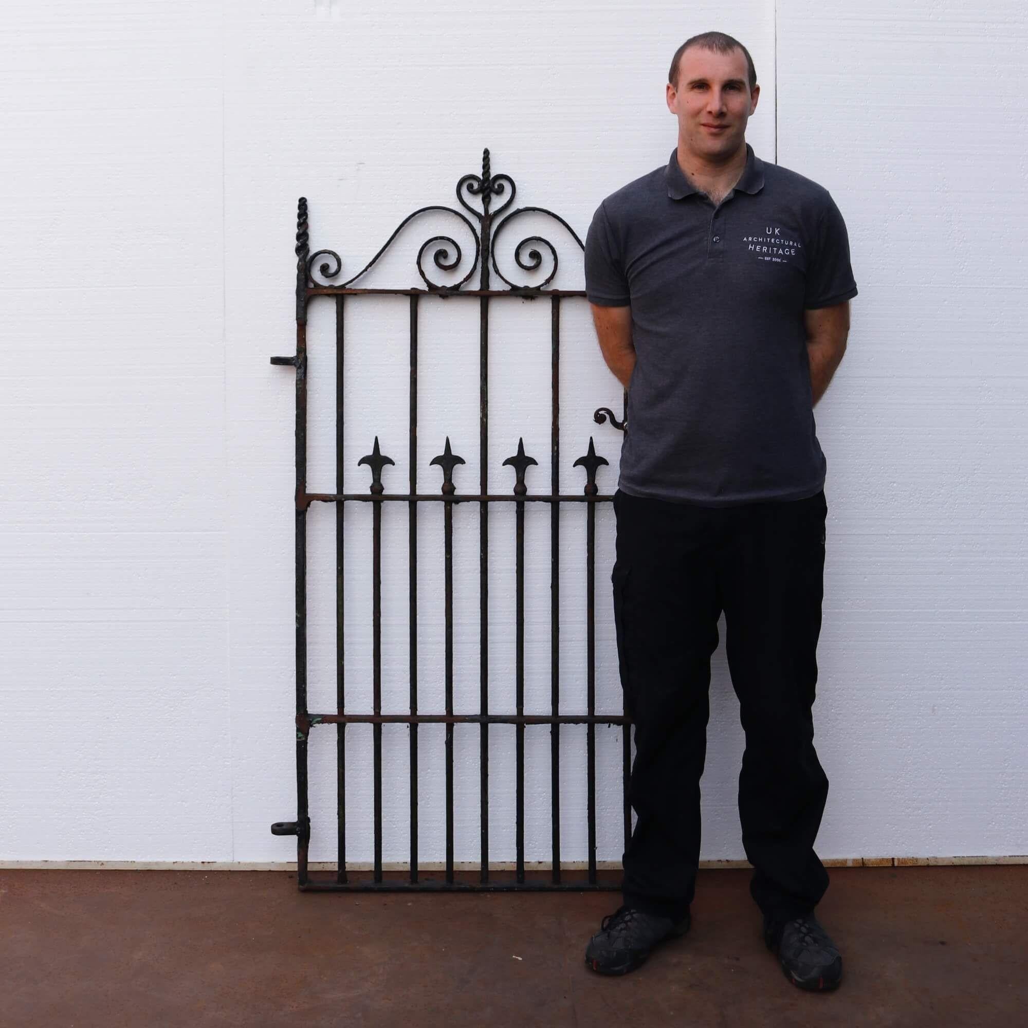 Elegant antique Victorian wrought iron pedestrian gate originating from circa 1860. With its generous height and scrolling, twisting design this lovely gate is smartly designed to give it a timeless quality. Its original working latch is another