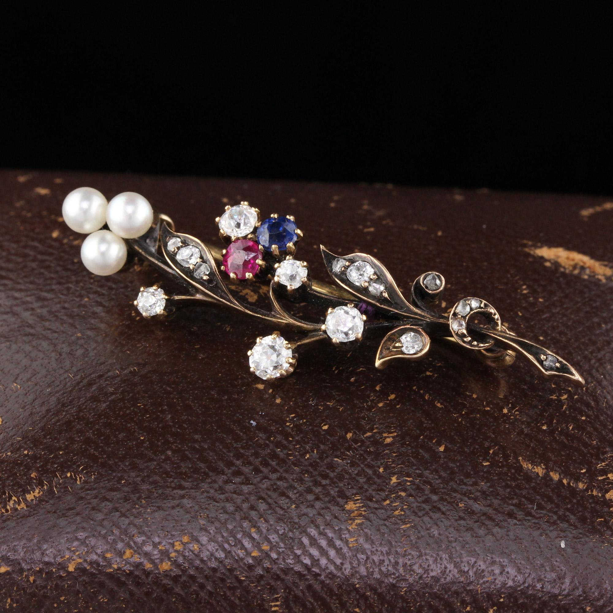Stunning Victorian floral bouquet brooch with old cut diamonds, pearls, sapphire & ruby.

Metal: Yellow Gold, Silver Top

Weight: 5.9 Grams 

Measurements: 13 x 44.2 mm