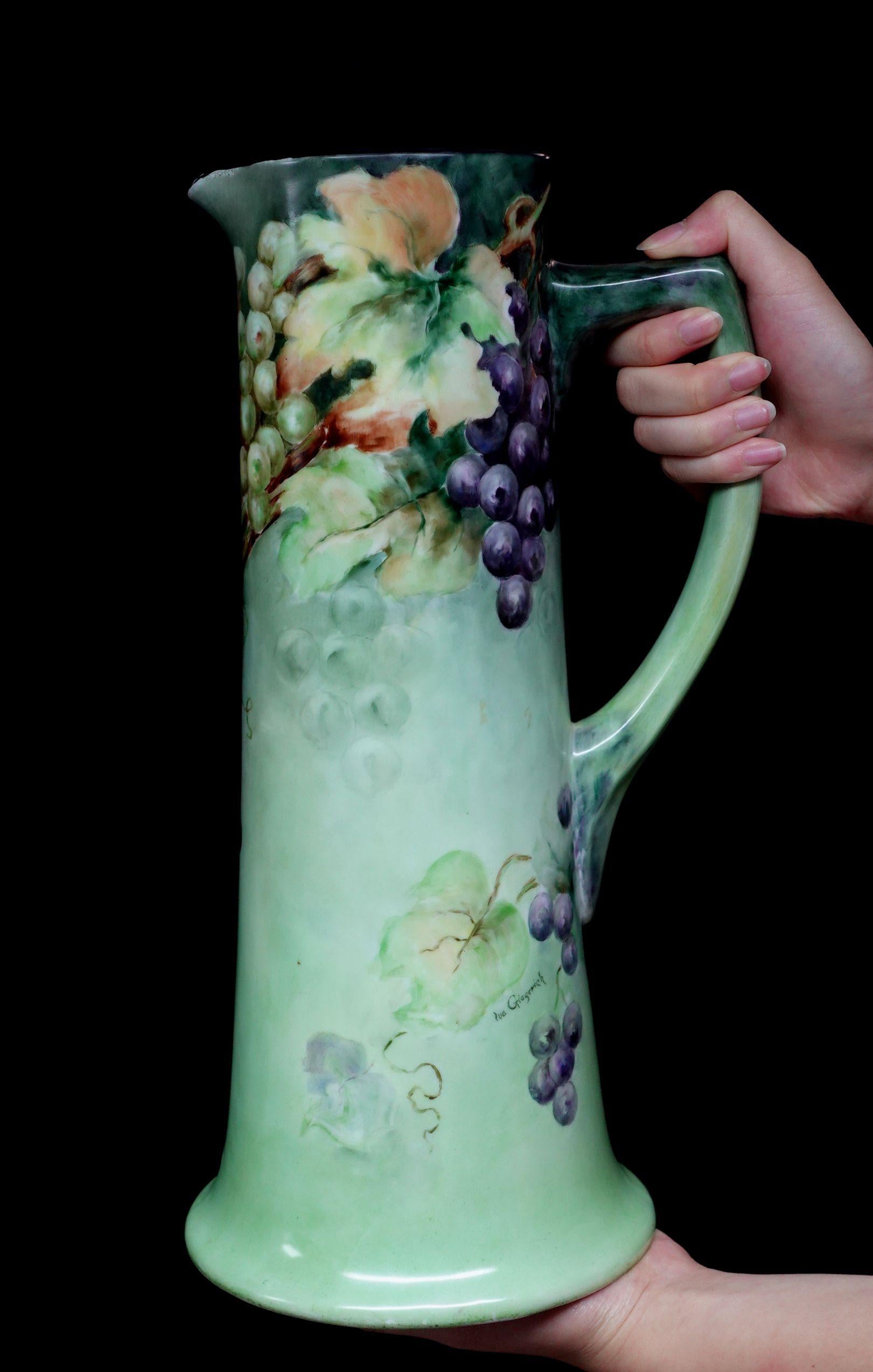 A wonderful antique Vienna Austria large tankard absolutely 100% hand-painted floral with the light green base throughout, grapes in purple and green presentation, red, and rich green leaves, delicate arrangement of the composition, more in some