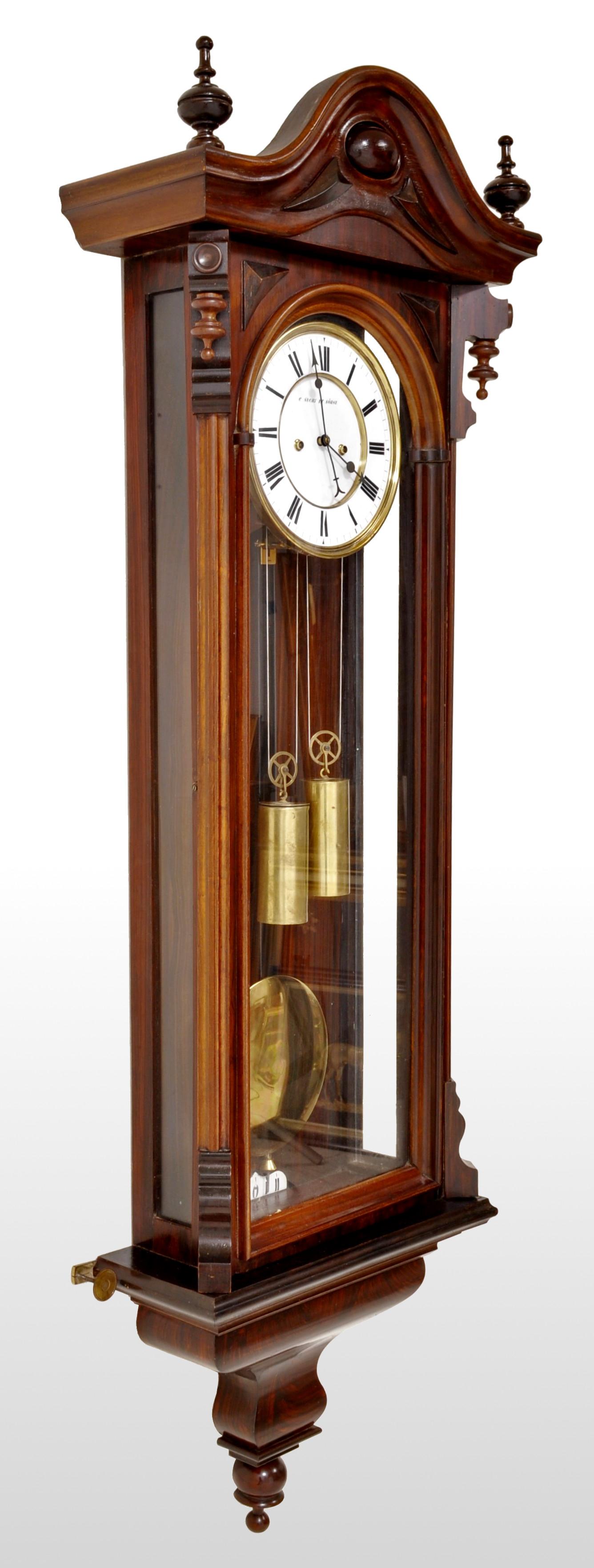Antique Vienna 8-day time and strike regulator/clock by Carl Suchy & Söhne, circa 1890. A fine regulator in a mahogany case and in the Biedermeier style, the arched top flanked by a pair of turned finials with corresponding finials on the door and