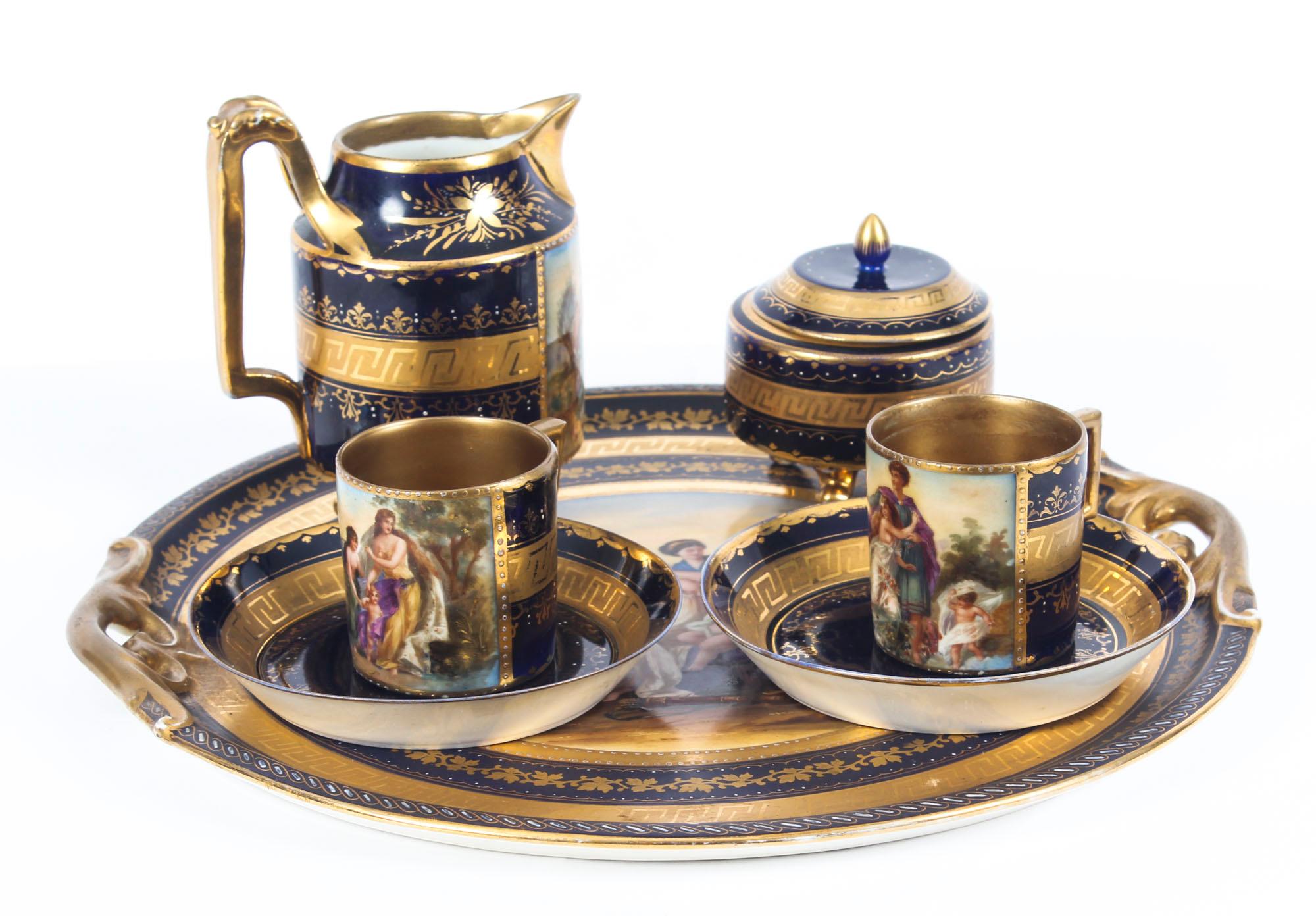 This is a delightful antique Vienna porcelain cabaret tray breakfast set, late 19th century in date.

It comprises a pair of coffee cups with saucers, a cream jug, a sugar bowl with lid and a cabaret tray. It is all beautifully gilded and painted