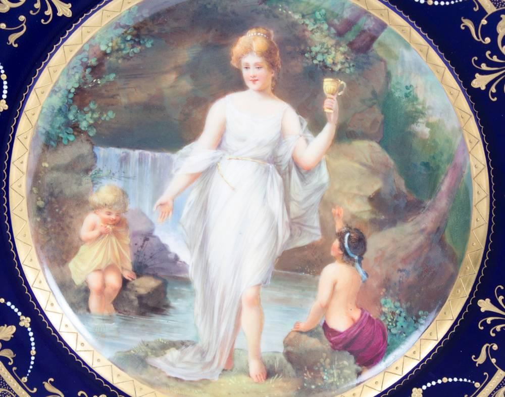 A wonderful antique 19th century Vienna porcelain cabinet plate, of circular form, beautifully hand painted with a romantic mythological scene depicting a classical lady with two young children, titled 