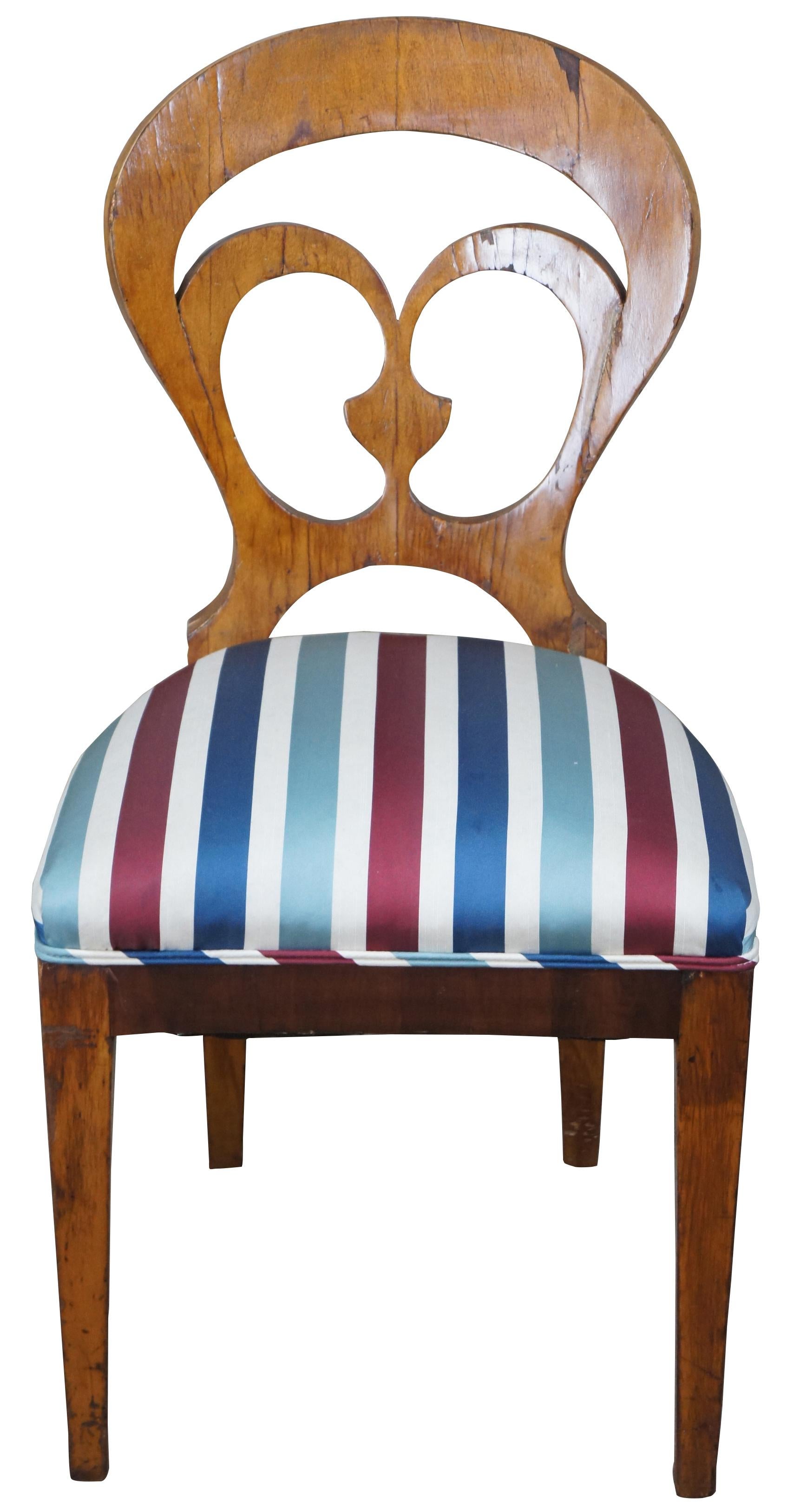 Early 19th century Biedermeier side chair. Features a balloon shaped back with pierced design over striped seat and square tapered legs.
 