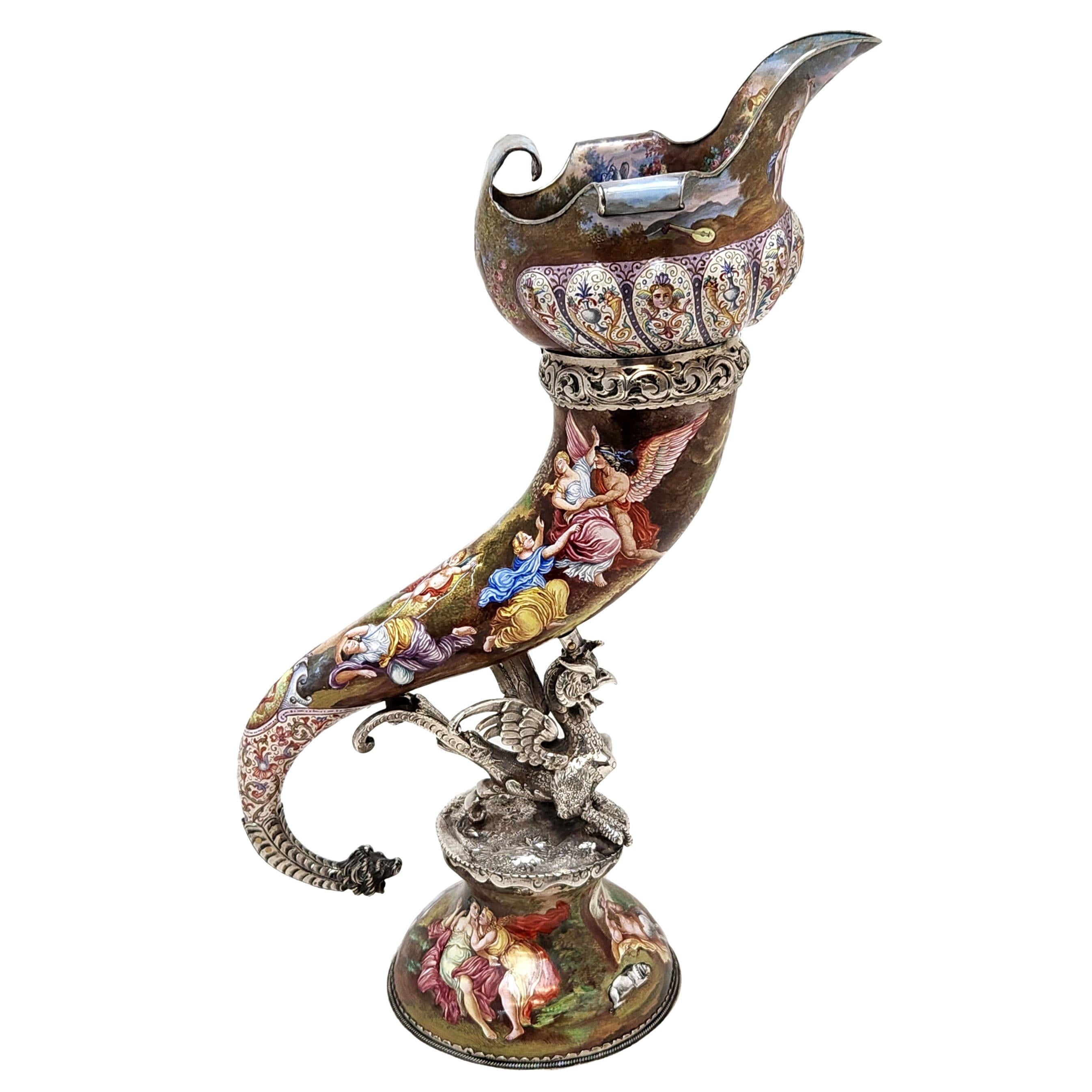 A magnificent Antique 19th century Silver & Viennese Enamel Vase in the shape of a large cornucopia supported by a silver griffin on a domed pedestal foot. The Cornucopia has a sumptuous flared and scrolled rim. The exterior of the cornucopia and