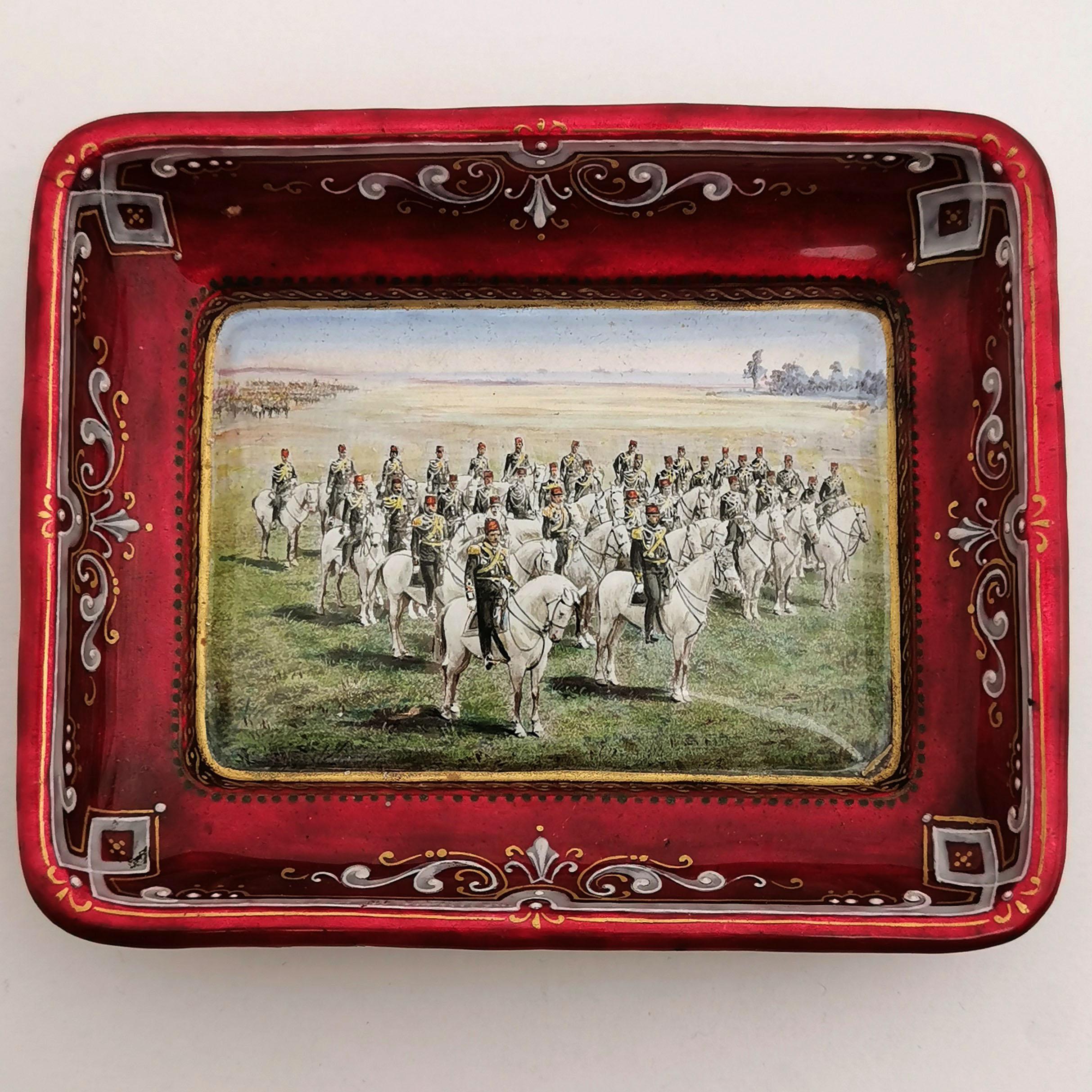 A lovely Antique Viennese Enamel Dish / Pin Tray featuring a wonderful enamel design showing a Turkish Army on Horse Back in a field. The sides of the Tray and the exterior are covered in a rich iridescent red with a white and gold border on the