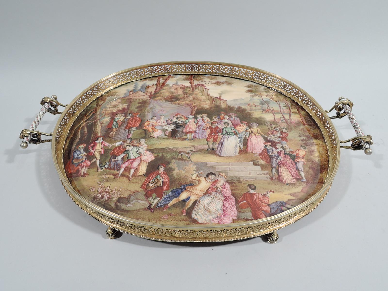 Austrian Rococo silver gilt and Viennese enamel tray, ca 1880. Oval enamel well depicting village green peopled with harp-strumming, minueting, love-making gentle folk. A flower wreath is suspended above a man and woman seated at a table with a