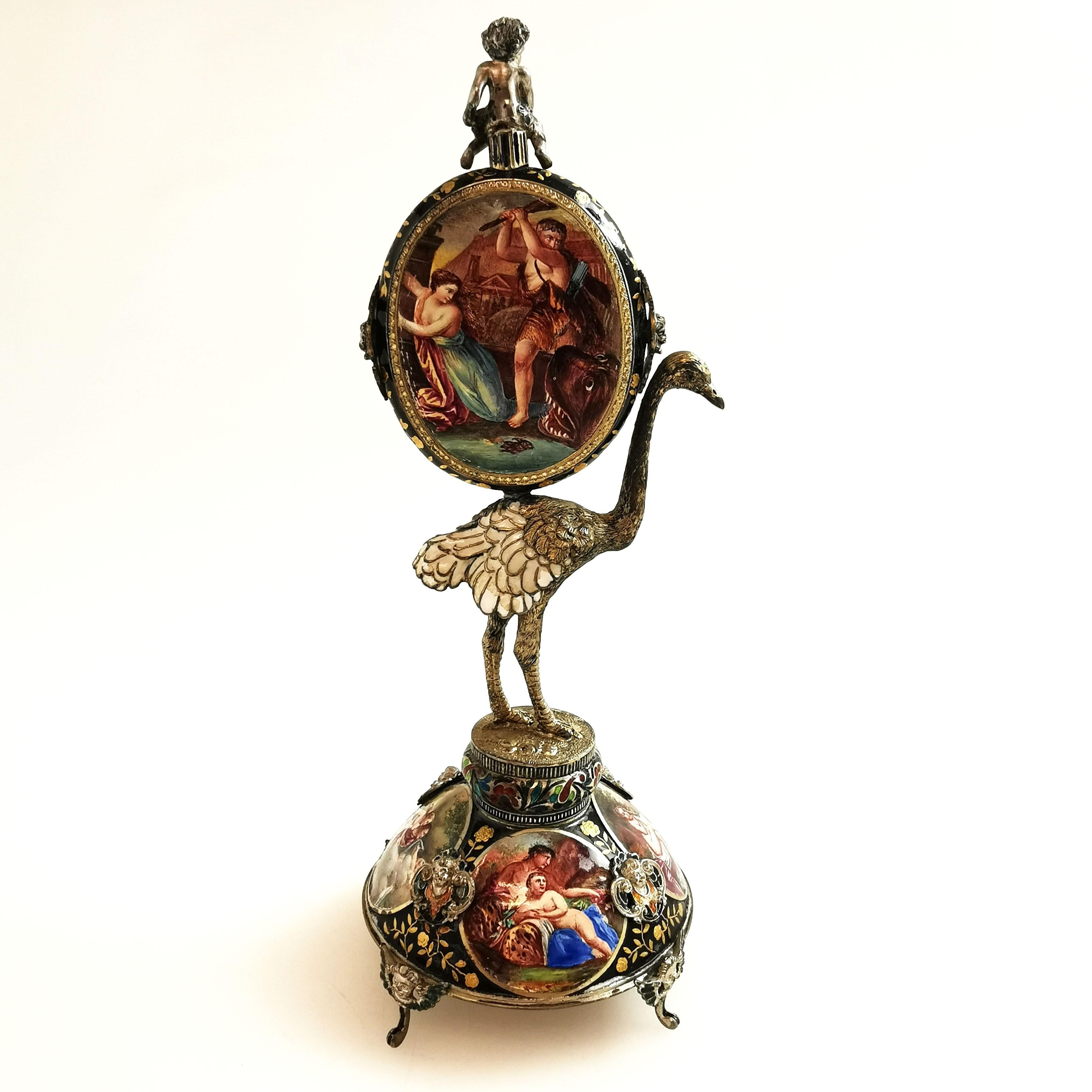 A pretty Antique Silver Gilt and Viennese Enamel Clock. This oval Clock rests on the back of an ostrich, which in turn stands on a domed base. The each surface of this Clock is covered in beautiful enamel details. The back of the Clock, the interior